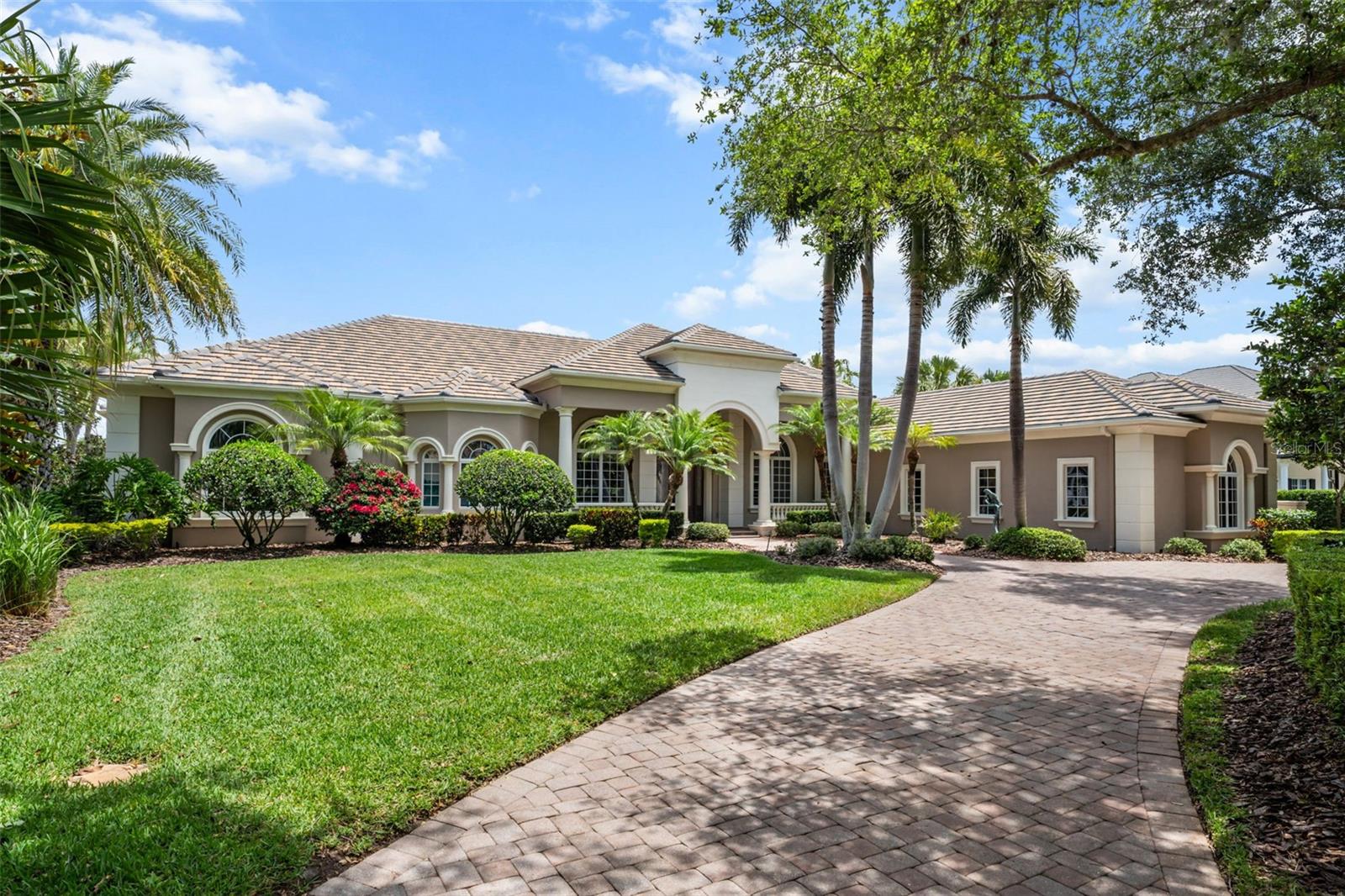 Refreshed and back on the market!  Lakefront masterpiece in the prestigious Founders Club.

Crafted by renowned builder Todd Johnston, this 5 bedroom, 5.5 bathroom home offers 6,800 square feet of sophisticated living space.  Luxurious craftsmanship abounds as you enter through the grand formal double-door entry featuring a mosaic marble inlay opening to coffered ceilings soaring above elegant hardwood and travertine marble floors throughout. Extensive millwork and hand built cabinetry highlight quality at every step. The gourmet kitchen boasts double Sub-Zero refrigerators, a six-burner Viking gas range with griddle, and a dedicated wine room with 100 bottle storage and double wine fridges.

The luxurious owners wing encompasses the primary bedroom, palatial bathroom, two large walk-in closets, and two additional bonus rooms perfect for a nursery, wellness space, secondary office, or additional living space. A spacious home theater is adjacent to this luxurious wing. Also on the first floor you'll find a large and sophisticated study with exquisitely crafted cabinetry and built-in book case for professionals working from home or private reading space. 

Guests will appreciate the first-floor guest suite with en suite bathroom, wet bar, and refrigerator. The downstairs bonus room offers flexibility as a fifth bedroom or game room.   Upstairs are two more bedrooms each with their own bathroom as well as a large family room and balcony.  

This estate lot brings sweeping views of the lake and golf course from the manicured lawns and the heated saltwater pool and spa surrounded by tumbled marble pavers and a fully equipped outdoor kitchen—ideal for entertaining.  A whole house generator, new roof (2020) and newer AC units.  

Residents of The Founders Club enjoy world-class amenities, including an 18-hole Robert Trent Jones Jr. golf course, elegant clubhouse with dining, fitness center, tennis and basketball courts, sand volleyball, and scenic walking trails. Don’t miss the opportunity to make this magnificent home yours!