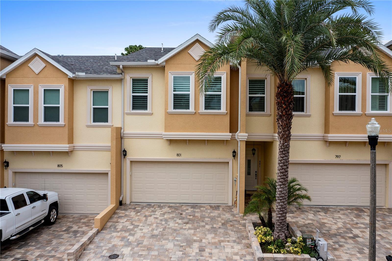 One can’t help but be impressed by the beauty and artistry woven into every detail of this 3 bedroom, 2 ½ bath townhome in the historical town of Tarpon Springs.  Conveniently located just off US 19, Cypress Trails Townhomes is in close proximity to Tarpon Lake, The Tarpon Springs Sponge Docks, Fred Howard Park, Sunset Beach, and multiple walk/bike trails throughout the area.  From the inviting foyer to the grandeur of the open floor plan and high ceilings, this luxurious home is tastefully decorated with warm finishes that makes one feel welcome.  The kitchen is a dream with plenty of wood cabinets for storage, stainless steel appliances, quartz countertops and designer backsplash.  Between the bar top counter, dining room, and living room there is plenty of room for friends and family to gather.   Just off the living room is a private lanai with beautiful travertine flooring. The half bath on the first floor is perfect for guest use and maintaining privacy.  The impressive master suite has not just one, but two closets.  One is a large walk-in while the other is a built-in closet.  The private master suite balcony offers a place of retreat after a long day, or a place to inspire oneself before the day begins.  Soaking away troubles in the garden tub of the master bath is also a wonderful option.  Either way, privacy is a premium with a split upstairs floorplan with bedrooms 2 and 3 on the opposite side of the master suite.  All 3 generous bedrooms are ready to receive your furnishings with room to spare.  Bathroom 2 is equipped with a tub/shower combo and a built-in linen closet for convenience.  The two-car garage has an inside storage room and overhead electric garage door opener.  This community is equipped with a gorgeous pool and club house that offers additional options for entertainment including gas grills.  From the doorbell to the kitchen sink, no detail has been overlooked.  Please be sure to view our virtual tour at https://my.matterport.com/show/?m=AF13a7aoEZu