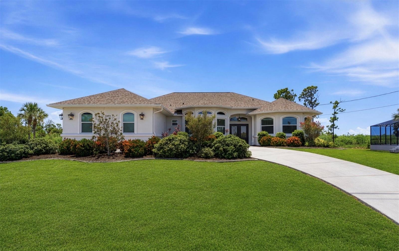Completely renovated, exceptionally protected, and perfectly positioned for privacy, this is the Florida dream home you’ve been waiting for! This beautifully updated four-bedroom, three-bathroom pool home offers 2,724 square feet of open-concept living space on a rare 0.66-acre double lot in Rotonda West, overlooking a peaceful preserve where you’ll enjoy tranquil views, abundant wildlife, and no rear neighbors. From the moment you arrive, you’ll appreciate the impressive curb appeal featuring fresh exterior paint, new landscaping, new front entry doors, and an expansive circular driveway leading to the spacious garage. Step inside to a warm, custom-designed interior that feels anything but cookie-cutter, where quality finishes and intentional design choices carry throughout the home. Upon entering, you are greeted by an abundance of natural light, soaring tray ceilings, architectural columns, fresh interior paint, and updated lighting and ceiling fixtures. New luxury vinyl flooring runs through most of the home, complemented by plush, ultra-comfortable carpeting in the bedrooms that adds warmth and livability. The remodeled kitchen features new cabinetry, granite countertops, under-cabinet lighting, and modern finishes ideal for both everyday living and entertaining. The primary suite is a true retreat, showcasing a fully renovated, modern, and stylish bath with a large walk-in tiled shower, dual sinks, and a freestanding soaking tub. Step outside to enjoy true Florida living on the oversized screened lanai overlooking the newly renovated heated pool, offering plenty of room for entertaining. Built for ultimate comfort and absolute peace of mind, the property features top-tier capital improvements including a newer roof, updated air conditioning with surge protection, a whole-house Generac generator with an underground propane tank, hurricane-impact windows, and Storm Smart hurricane protection for the lanai. Complete with a renovated pool, new pool heater, and new lanai screening, this move-in-ready home offers the perfect blend of style, privacy, and security.