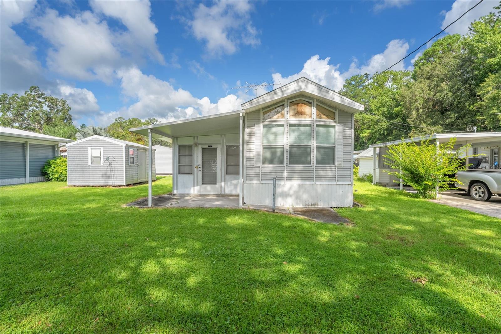 BACK ON MARKET -- due to no fault of the seller or property! BRAND NEW ROOF INSTALLED! Searching for the perfect 55+ community in Florida where peace and comfort come together? Welcome to Camper's Holiday, a vibrant and active neighborhood designed for those who want to enjoy the best of serene, Florida living. Surrounded by natural beauty, mature trees, and tranquil scenery, this gated community offers both privacy and convenience—just minutes from all that Brooksville has to offer. Enjoy an array of amenities including: complimentary internet and cable TV, a geothermal, Olympic-sized swimming pool for year-round relaxation, a recreational hall with a library, pool table, stage, and scheduled activities, large outside pavilion, fire pits, shuffleboard courts, playground and access to Sparkman Lake— the perfect spot for fishing, boating (with ramp), or soaking up the sun! Lot A-27 is ideally situated on a quiet, paved dead-end road and includes a 2002 Destination Trailer with full utilities, an outbuilding for extra storage, and comes fully furnished—just bring your personal items and settle in! Don't miss out on this move-in-ready opportunity in one of Florida's most peaceful 55+ parks. Call today to schedule your private showing!