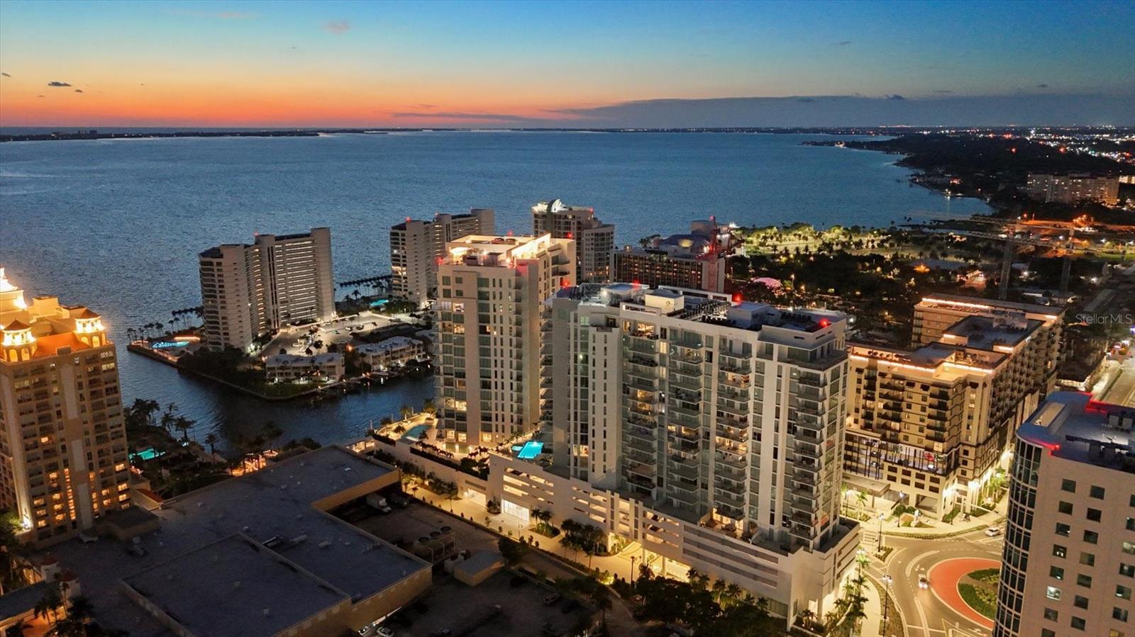 Discover an elevated lifestyle at Bayso, Sarasota’s most coveted luxury tower where contemporary urban elegance meets laid-back coastal charm. Perfectly positioned at the vibrant Quay Sarasota waterfront district, this 18-story residential landmark offers walkable convenience to the city's acclaimed arts, dining, and cultural scene, making it an ideal retreat for those who desire both sophistication and connection. Perched on the 17th floor, Residence 1704 is a beautifully designed, light-filled sanctuary that offers 1,689 square feet of airy, open living space. This two-bedroom, three-bath residence exudes effortless style with 10-foot ceilings and expansive floor-to-ceiling glass windows and sliders, opening to a 33’ x 8’ private terrace. From here, take in panoramic views of Sarasota Bay, city skyline, and breathtaking sunsets. Inside, the residence has been thoughtfully furnished with curated European antiquities, offering a unique blend of character and contemporary flair. The open-concept layout flows seamlessly from the living area to the chef’s kitchen, where Italkraft Euro-style cabinetry, quartz countertops, and premium JennAir stainless steel appliances create a striking and functional space. The owner’s suite features a generous walk-in closet and a spa-inspired bathroom with Grohe fixtures, perfect for unwinding after a day by the sea. The guest bedroom suite offers equally impressive views and a private en-suite bath. A third full bathroom with walk-in shower and a spacious laundry room add to the home’s thoughtful design. Bayso’s exceptional amenities are designed for elevated everyday living. The ground floor features 24-hour conceierge service, a professional fitness room, community room with bar, a conference room and private work rooms with high-speed internet. On the fifth level, residents enjoy a resort-style pool and spa, expansive sun decks, a grilling station, club room and a residents’ lounge with multiple gathering spaces. Additional features include a dog park and pool baths. Additional amenities include one-reserved parking space, a secure storage unit, and a bike room for easy exploration of downtown and the bayfront paths. The location is just minutes from award-winning Siesta and Lido beaches, world-class shopping, fine dining, and Sarasota-Bradenton International Airport, this residence combines the best of Florida living with the understated elegance of a private coastal retreat. If you’re seeking a sophisticated urban home with a coastal soul, Residence 1704 at Bayso welcomes you.