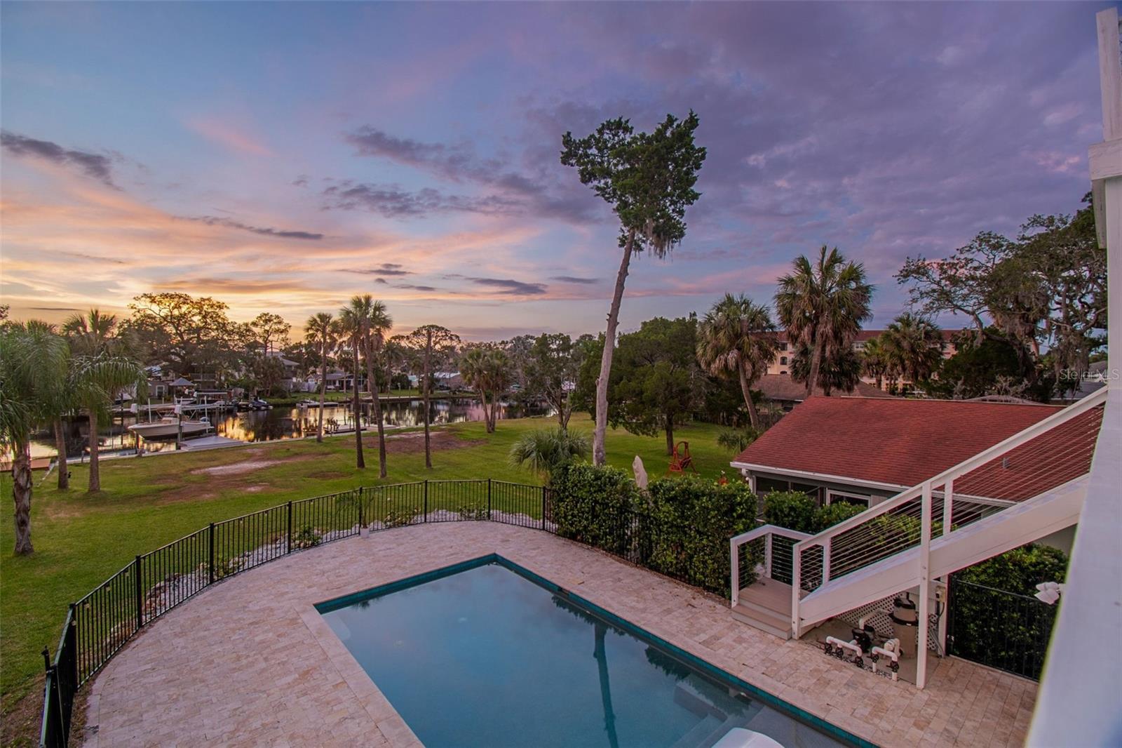 Live the waterfront lifestyle you’ve been waiting for in this stunning Gulf-access pool home in the heart of New Port Richey, set on an oversized waterfront lot at .29 acres.

Soaring high ceilings and a bright open floor plan set the tone, paired with modern finishes including hard-surface countertops, shaker cabinets, stainless steel appliances, and recessed lighting.

The entire third floor is a private primary retreat with a waterfront balcony, walk-in closet, and spa-style bath with dual vanities and a freestanding double slipper tub.

Out back is where this home truly shines—saltwater pool, paver deck, in-pool chaise loungers, electronic sunshade, and a 12,000 lb boat lift for effortless Gulf access. The west-facing backyard delivers incredible nightly sunsets over the water.

Additional highlights include a 4-car garage, hurricane-impact windows, and a high-and-dry elevation with no water intrusion. Transferable flood insurance is just $707/year.

Location is everything—just minutes to vibrant downtown New Port Richey with local restaurants, waterfront dining, live music, and nightlife. A public boat ramp is also just down the street, adding even more convenience for boating and exploring the Gulf. Boat available for purchase separately.

This is true Florida waterfront living—inside and out.