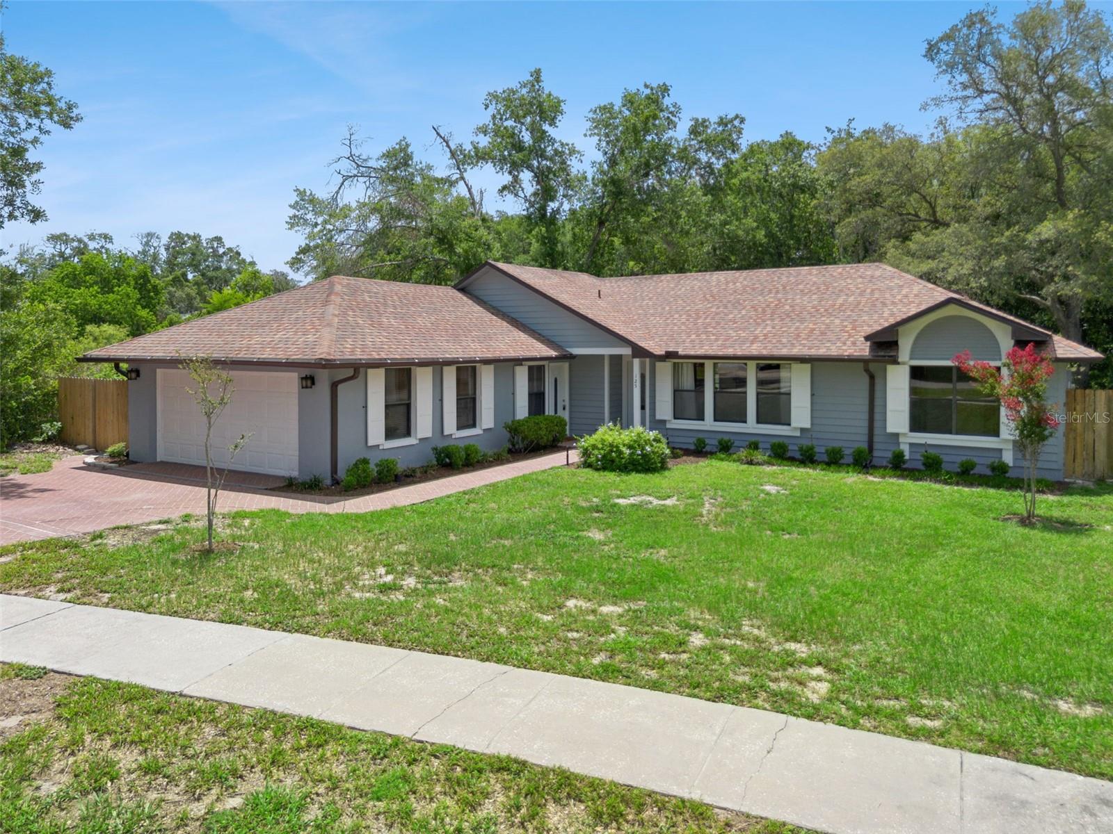 Welcome to 125 Donna Circle, a spacious 4-bedroom, 2-bath home tucked away on an oversized lot in Sanford's established Hazel Glen neighborhood. With over 2,000 square feet of living space, soaring ceilings, abundant natural light, and a private wooded backdrop, this home offers a rare combination of space, flexibility, and privacy.

The heart of the home is the open living area, where vaulted ceilings and large windows create a bright, inviting atmosphere. Custom built-in shelving adds character and functionality, while the updated kitchen features modern cabinetry, solid-surface countertops, stainless steel appliances, and a layout that flows seamlessly into the dining and living spaces.

The primary suite offers generous proportions, an updated en-suite bath, and ample closet space. Two additional bedrooms provide comfortable accommodations for family or guests, while the fourth bedroom opens the door to countless possibilities. With its private exterior entrance and substantial size, this flexible space is ideal for a home office, media room, game room, fitness studio, guest quarters, multigenerational living, or, subject to local regulations and approvals, a future income-producing opportunity.

Beyond the main living areas, you'll find a bright Florida room under air and a large screened porch overlooking the fenced backyard. The expansive yard backs to a wooded area with no rear neighbors, creating a peaceful setting that's increasingly difficult to find.

Perfectly positioned near the Sanford and Lake Mary city lines, residents enjoy convenient access to Historic Downtown Sanford, Lake Monroe, shopping, dining, major employers, Orlando Sanford International Airport, SR-417, and I-4. Zoned for sought-after Lake Mary schools, this home offers the space, versatility, and location that today's buyers are looking for.

Whether you're searching for room to grow, space to work from home, accommodations for extended family, or simply a property with privacy and flexibility, 125 Donna Circle is ready to welcome you home.
