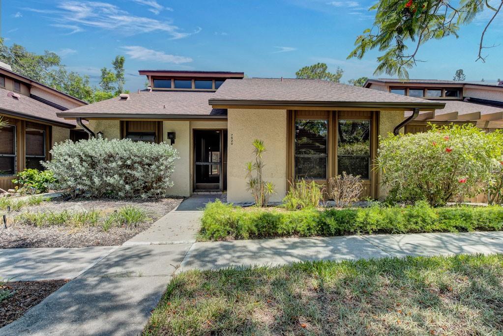 Less than nine minutes from Anna Maria Island, this private West Bradenton villa offers exceptional access to the beaches, dining and relaxed coastal character of the island, together with the added advantage of a Flood Zone X location. Priced below comparable homes to preserve a meaningful renovation budget, it offers the freedom to create a refined coastal residence without paying for someone else’s design choices.

The former flooring has already been removed from the main living areas and bedrooms, allowing the next owner to select the materials and finishes from the outset. The kitchen and baths are clean and functional, including a new quartz-topped vanity in the guest bath, while remaining ready to be reimagined in a style that feels entirely personal.

The single-level, two-bedroom, two-bath residence spans 1,249 square feet and reflects the distinctive low-slung architecture of Pine Bay Forest. Two screened lanais extend the living space outdoors, including a secluded rear retreat framed by mature landscaping and complete privacy from neighboring homes.

Set across 22 wooded acres near Robinson Preserve and Palma Sola Bay, the community is defined by canopied oaks, tropical gardens and one-story residences. Private walking trails wind through the grounds, leading to a waterfront observation deck overlooking Palma Sola Bay—an inviting setting for sunsets, coastal breezes and quiet moments by the water. Residents also enjoy a pool, tennis, pickleball and shuffleboard.

For the buyer drawn to Anna Maria Island, architectural character and the freedom to renovate with intention, this is a rare combination of location, privacy and value.