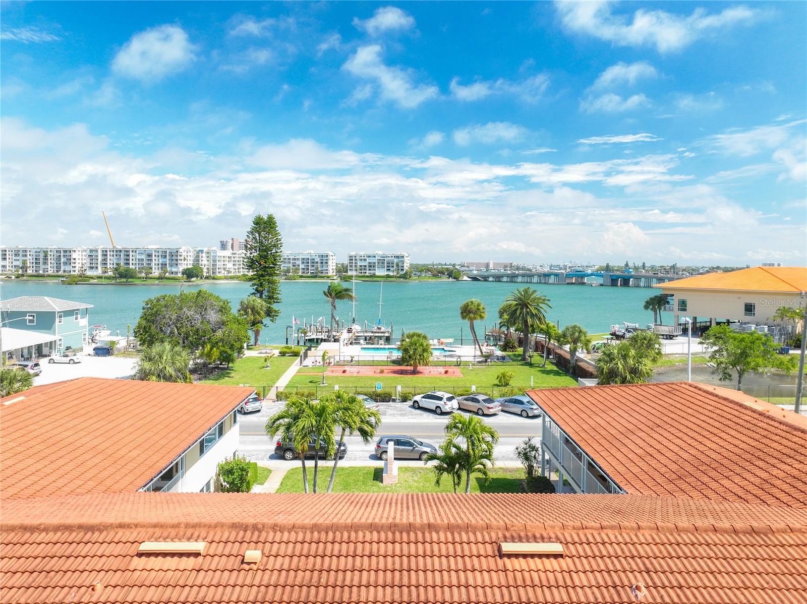 MAJOR PRICE IMPROVEMENT*** Hurry before it's too late **Picture yourself sitting around the WATERFRONT HEATED COMMUNITY POOL, the cool breezes gently blowing, as you close your eyes, breathe in the fresh salt air, and feel the sun warm you. Does that feel peaceful? Invigorating? If you are seeking your own private retreat to unwind & still wanting the convenience & accessibility to various amenities, along with the RENTAL INVESTMENT POTENTIAL, your search is over. This spacious turn-key 1-bedroom condo nestled within a waterfront complex is perfect!.  Don’t let the square footage fool you. Tucked in the south corner on the 2nd floor, upon entering the condo, you're pleasantly surprised by the sense of openness and brightness. The living area features bamboo flooring and is thoughtfully laid out, with tasteful furnishings arranged to maximize space and comfort. A cozy sofa sits opposite a wall-mounted television, perfect for unwinding after a day of exploring the nearby attractions. Adjacent to the living area is a compact yet functional kitchenette, complete with sleek custom-made concrete countertops, a floating solid wood breakfast bar, Designer bamboo cabinetry, and modern appliances, including drawer style fridge & freezer. The remarkably large bedroom, with the same bamboo flooring, is a peaceful sanctuary and includes a walk-in closet. 2 windows in the bedroom offer abundant natural light and the perfect cross breezes. Your first thought as you make your way into the vintage & functional washroom will be one of nostalgia. Outside the condo, the waterfront complex and community offer an array of amenities and recreational activities to enhance your stay. Are you a boater? The condo complex offers a boat slip on a first-come, first-served basis right on the premises. Not a boater? Take a refreshing dip in the sparkling pool, sign up for a class at the community center across the street, make your way south a short 4 blocks to Corey Ave. Offerings include multiple restaurants, bars, shopping, and a weekly market. If the beach is more to your liking, Upham Beach is less than 1 mile away. Whether you're in search of tranquility, convenience, investment, or personal fulfillment, this cozy 1-bedroom condo within a waterfront complex offers an ideal fusion of comfort, ease, and coastal allure. Whether as a primary residence or a vacation home, this condo offers the opportunity for a personal retreat. For buyers seeking a sanctuary where they can escape from the stresses of daily life or enjoy leisurely getaways, this property satisfies the need for a dedicated space to relax, recharge, and create lasting memories with loved ones. ALL AGES WELCOME- SHORT TERM RENTALS ALLOWED. Updates include: updated electrical panel and newer hurricane impact windows. You will love this well cared for condo AND being minutes away from the events & activities the surrounding area has to offer, from the soft sand of the local beaches, to Downtown St. Petersburg (20 min) to Eclectic Gulfport (12 min). Just blocks from shopping, restaurants, medical & religious facilities, bus lines & parks. 45 min drive to Tampa International Airport, 35 minutes to PIE. .**Schedule your private tour today, properties like this are hard to find.**Claims made in this listing are deemed correct by sellers, but the buyer understands it is their responsibility to confirm all info as some could change from time of listing. See 3D tour.  PLEASE NOTE: POOL CURRENTLY BEING REHABBED