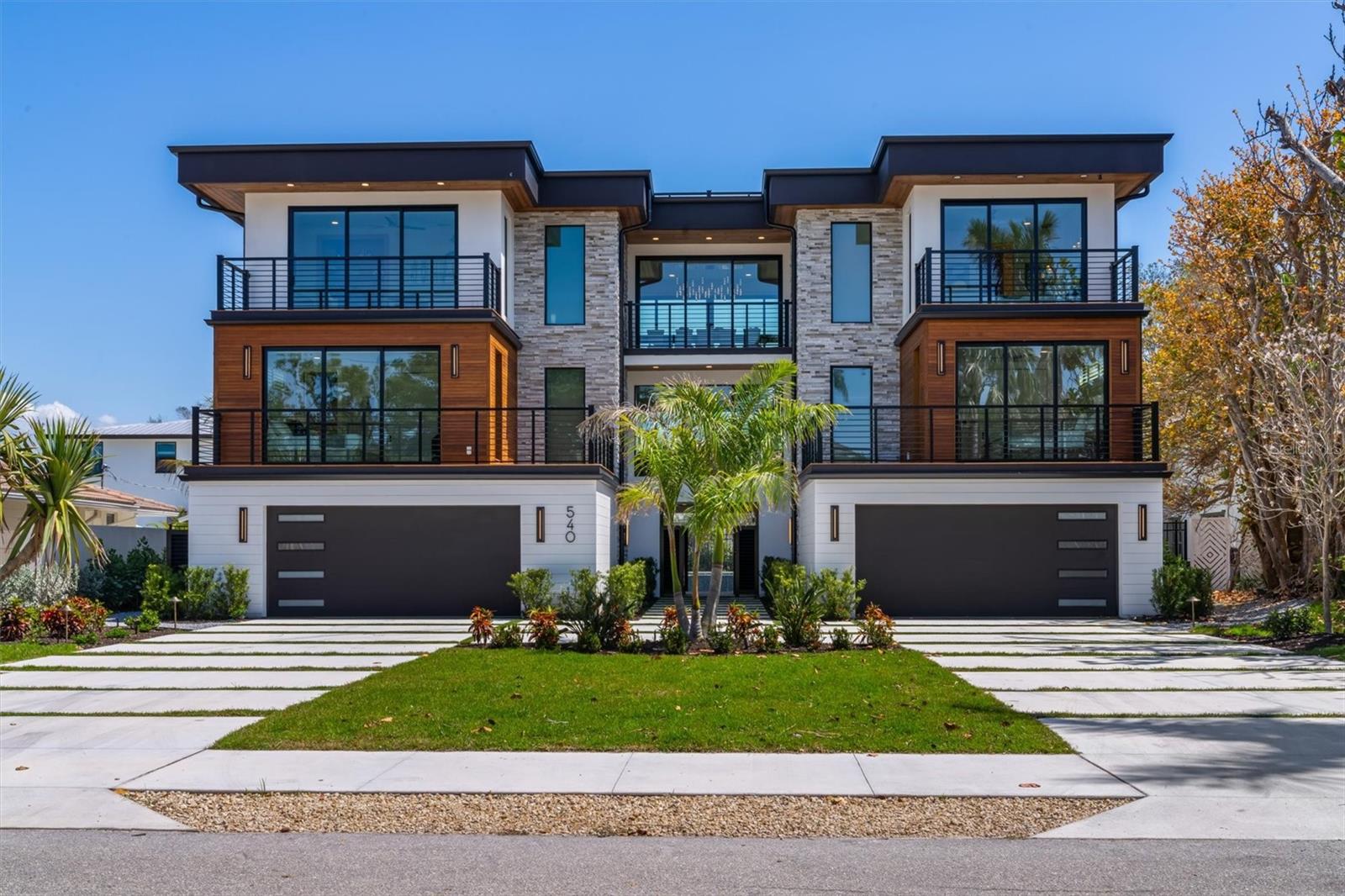 This exquisite residence combines sophisticated contemporary design with exceptional income-producing potential, offering 9,258 square feet of resort-style living just steps from the Gulf beaches. With 5,331 square feet of refined interior space and a curated collection of premium furnishings, the home is ideal as a luxurious family retreat or a high-performing corporate getaway. Zoned for seven-day rentals and supported by a strong rental history, the property commands approximately $1,800 per night in season and $1,300 per night out of season, making it an attractive opportunity for investors or business owners seeking both personal enjoyment and revenue generation. 
The gourmet kitchen centers around a waterfall-edge island and features a Sub-Zero refrigerator, Wolf eight-burner gas range, dual dishwashers, floating shelves and sleek European-style cabinetry. Bespoke finishes elevate every space, including quartz countertops, designer lighting, an interior elevator, custom tambour wood walls, artisanal iron stair rails, 7-inch baseboards and 8-foot interior doors. Each floor includes a wet bar with beverage refrigerators, ice makers or dishwashers, creating effortless flow for entertaining.   
The primary suite offers a serene private retreat with walk-in closets and a spa-inspired bath featuring a backlit marble wall, designer fixtures and a walk-in shower with rain and handheld showerheads. Five additional bedrooms each feature uniquely designed en-suite baths with custom mirrors, distinctive tilework, sleek cabinetry and under-lit vanities.   Outdoor living is extraordinary, with more than 3,300 square feet of covered patios and six balconies culminating in a rooftop deck with 360-degree views of the Gulf, bay and city skyline. The summer kitchen includes a Heston Aspire grill and wet bar. The fenced backyard is a tropical oasis with a heated saltwater pool, waterfall, fiber-optic lighting, a 12-person spa and a private putting green. Multiple lounging and dining areas accommodate everything from family gatherings to corporate retreats, complete with TVs, beverage refrigerators and game spaces for pool or ping pong.   Advanced smart-home technology includes a comprehensive surveillance system with high-definition cameras, whole-property Wi-Fi, intelligent access control, programmable architectural lighting and motorized window treatments. A Sonos multi-room audio system and 12 high-definition TVs enhance entertainment throughout.  Architectural highlights include stacked-stone and wood cladding, horizontal balcony rails, and Ipe wood on balconies and the rooftop deck. Hurricane-rated windows and doors, tongue-and-groove ceilings and travertine pavers complete the exterior.   Ideally located near pristine Gulf beaches, St. Armands Circle and downtown Sarasota’s dining, arts and entertainment, this residence offers the rare combination of luxury living, strong rental income and exceptional appeal for families, executives or investors.