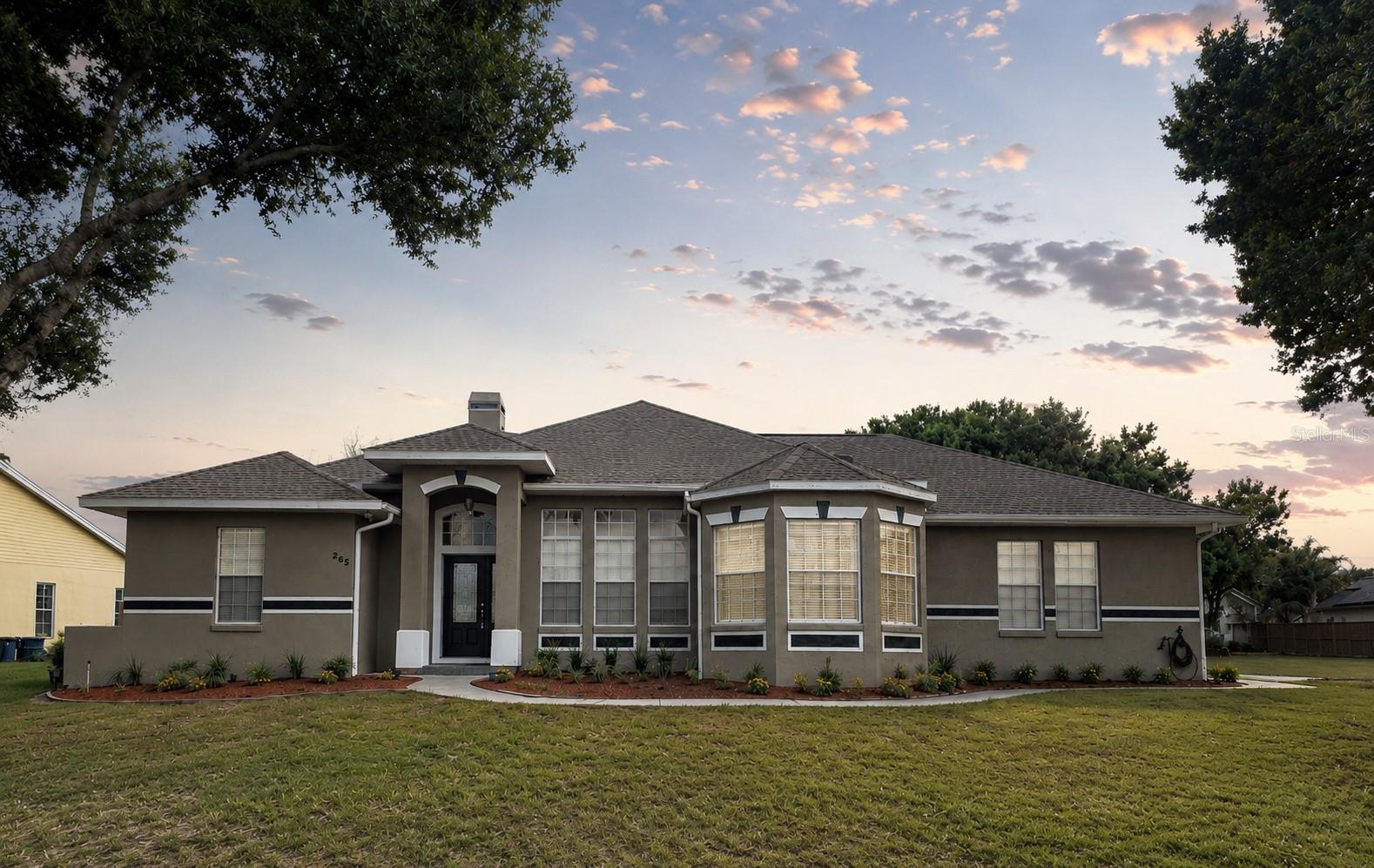 LOCATION, LOCATION, LOCATION! Welcome to lakeside living at its finest in the desirable Lake Agnes community of Polk City. Situated on an oversized corner lot with private dock access to Lake Agnes directly across the street, this beautifully maintained 3-bedroom, 2-bathroom pool home offers the perfect blend of comfort, functionality, and outdoor living.

Step inside to discover a bright, open-concept floor plan filled with natural light from oversized windows. Property features a bonus room that can be used as an office, a den, or a fourth bedroom. The spacious living room centers around a cozy fireplace, creating the perfect gathering space, while the adjacent dining area features a charming bay window overlooking the property. The kitchen is designed for both everyday living and entertaining, complete with stainless steel appliances, a breakfast bar, dual sink, abundant cabinet storage, and an additional flex space ideal for a breakfast nook or sitting area. 

The split-bedroom floor plan provides privacy for the primary suite, which features an elegant tray ceiling and a spacious ensuite bathroom with dual vanities, a garden tub, separate shower, and generous storage. Three additional bedrooms are located on the opposite side of the home, along with a secondary bathroom that conveniently provides direct access to the lanai and pool area. 

Outdoor living truly shines with a screened-in pool and spa, creating your own private retreat for relaxing afternoons, weekend gatherings, and memorable BBQs. The oversized, fully fenced backyard offers plenty of room for pets, play, and entertaining.

Additional features include a dedicated laundry room with utility sink and storage cabinets, two separate garages with individual driveways providing ample parking and flexibility, and numerous recent updates for peace of mind, including a new roof, new flooring, new water heater, newly screened pool enclosure, and new pool heater. One of the A/C systems is brand new.

Conveniently located less than five minutes from Publix, shopping, dining, and downtown Polk City, with easy access to I-4, Highway 33, and the Polk Parkway (570), this deed-restricted community offers the rare combination of tranquility, convenience, and lake access. Don't miss your opportunity to own this exceptional property in one of Polk City's most desirable locations.