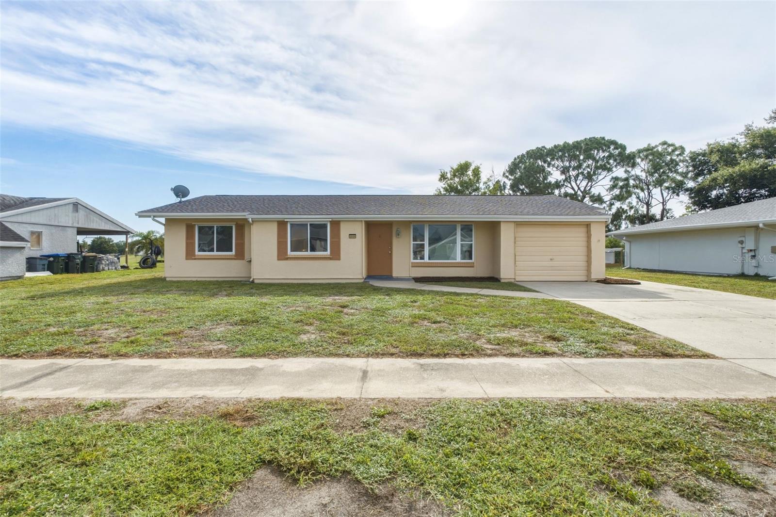 This ADORABLE 3 bedroom, 2 bath home has a NEWER ROOF (2022), NEWER AC (2022), NEWER FRONT WINDOWS, NEWER HURRICANE IMPACT BACK SLIDERS (2023), and NEWER WATER HEATER (2021)! FULLY-FENCED BACKYARD! In addition, the entire interior of the home has just been professionally painted and new carpet installed in both guest bedrooms. As you enter the home, you will be greeted by the generous living room, neutral tile floors, fresh paint, and tons of natural light, making the home feel spacious and inviting. The kitchen opens up to the dining room and back living room and has a breakfast bar & closet pantry! To the left, past the dining room is the hallway leading to all of the bedrooms. Both of the guest bedrooms are quite roomy and feature brand new carpet. A guest bathroom is located across the hallway from the bedrooms. At the end of the hall is the primary suite with a walk-in closet and ensuite bathroom. The back sliders in the back living room lead out to your very own fenced backyard! A portion of the garage has been converted into a storage room but can easily be converted back to a garage by just tearing out the framing and drywall. This neighborhood has no CDD fee and the HOA fee is quite reasonable. Just $300 per year. Located on a quiet street in X flood zone — so no need for flood insurance! You can’t beat this location in North Port- with quick access to both US-41 & I-75! Located near great schools (including Imagine School) award winning golf courses, parks/playgrounds and warm gulf beaches. Coco Plum plaza is nearby with its many shops and restaurants. North Port aquatic center is also in close-proximity, with heated pool, waterpark, and discounted entry for North Port residents! Within the city of North Port, you will also find downtown Wellen Park— featuring Cool Today Park (Atlanta Braves Spring Training Stadium)! Downtown Wellen is situated around a huge lake with walking/jogging paths, kayak rentals, boutique shopping, restaurants, coffee shop, wine bar, ice cream shop, food trucks, splash pad, playground, weekly farmer’s market, and TONS of events! Schedule your showing today!