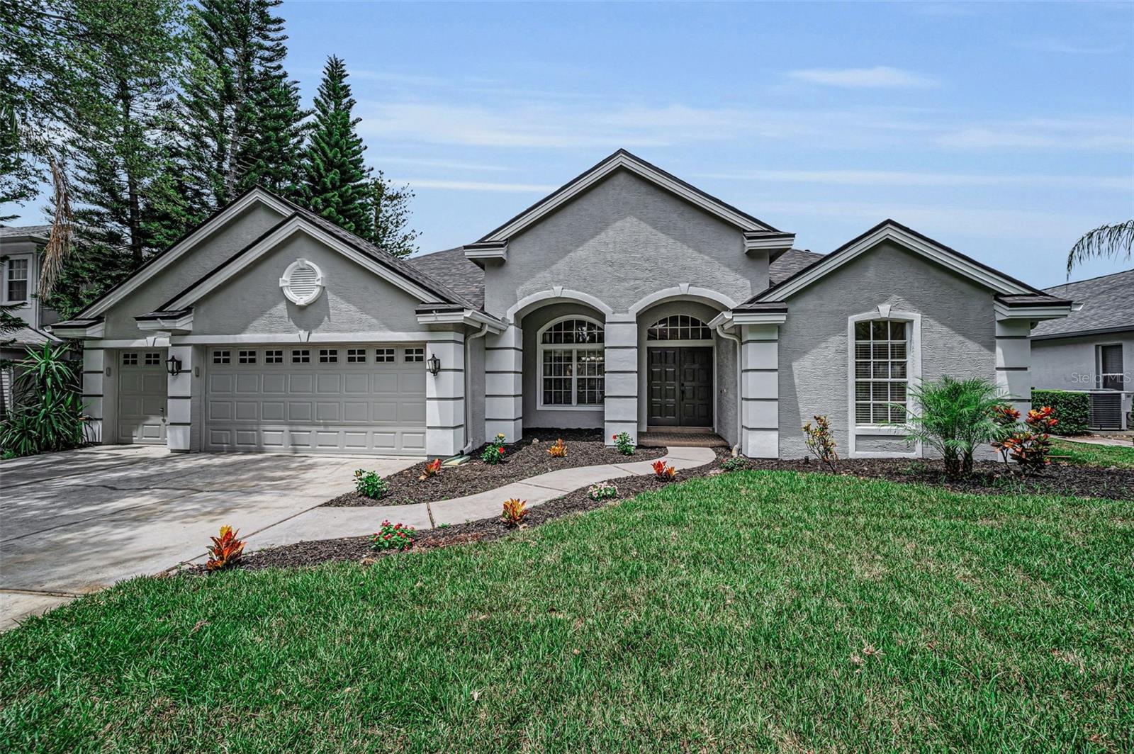 Welcome to this beautifully updated 4-bedroom, 3.5-bath pool home in the desirable Lynnwood neighborhood of Lansbrook. Built with solid block construction and offering a 3-car garage, this home features a functional 3-way split floor plan that provides privacy, flexibility, and comfortable everyday living.
Formal living and dining rooms provide inviting spaces for entertaining and flow into the heart of the home: a well-appointed kitchen featuring a Jenn-Air cooktop, double ovens, Bosch dishwasher (2024), and new quartz countertops, backsplash, and sink (2026). A concealed cabinet-style door opens to a spacious walk-in pantry, providing exceptional storage and a distinctive custom detail.
The primary suite is a private retreat with two large walk-in closets and an ensuite bath featuring custom maple cabinetry, travertine finishes, a double vanity, soaking tub, walk-in shower, and private water closet. Two secondary bedrooms share an updated bath, while the fourth bedroom is privately located at the rear of the home and offers convenient access to the upgraded pool bath, making it ideal for guests or multigenerational living. 
Upstairs, the versatile bonus room includes a large walk-in closet and updated half bath, creating flexibility for a fifth bedroom, home office, media room, or playroom. Engineered hardwood flooring extends throughout the bedrooms, family room, and bonus room, while crown molding, custom wood shutters add polished character. All bathrooms have been upgraded with travertine stone, and custom maple cabinetry.  The office and pool bath feature custom poplar wood wainscoting with dimensional detailing and decorative moldings. 
Enjoy peaceful pond views and no direct rear neighbors from the screened lanai, enhanced by a panoramic screen opening for unobstructed views. The outdoor living area features a saltwater pool and spa remodeled in 2024, with a premium Wet Edge pebble-and-glass-bead finish, travertine pool deck, and custom-fabricated travertine drain covers for a seamless look.
Additional updates include a new roof and exterior paint in 2026, new front-yard sod in 2026, and dual-source irrigation that can operate on either well or county water.
Lansbrook residents enjoy miles of shaded walking trails, parks, playgrounds, and courts for pickleball, volleyball, soccer, and basketball. The community also offers private Lake Tarpon access with a boat ramp, fishing pier, and picnic areas. Conveniently located near highly sought-after schools, the Pinellas Trail, YMCA, golf courses, shopping, dining, and Tampa International Airport, this home offers an exceptional combination of upgrades, privacy, and Florida lifestyle.