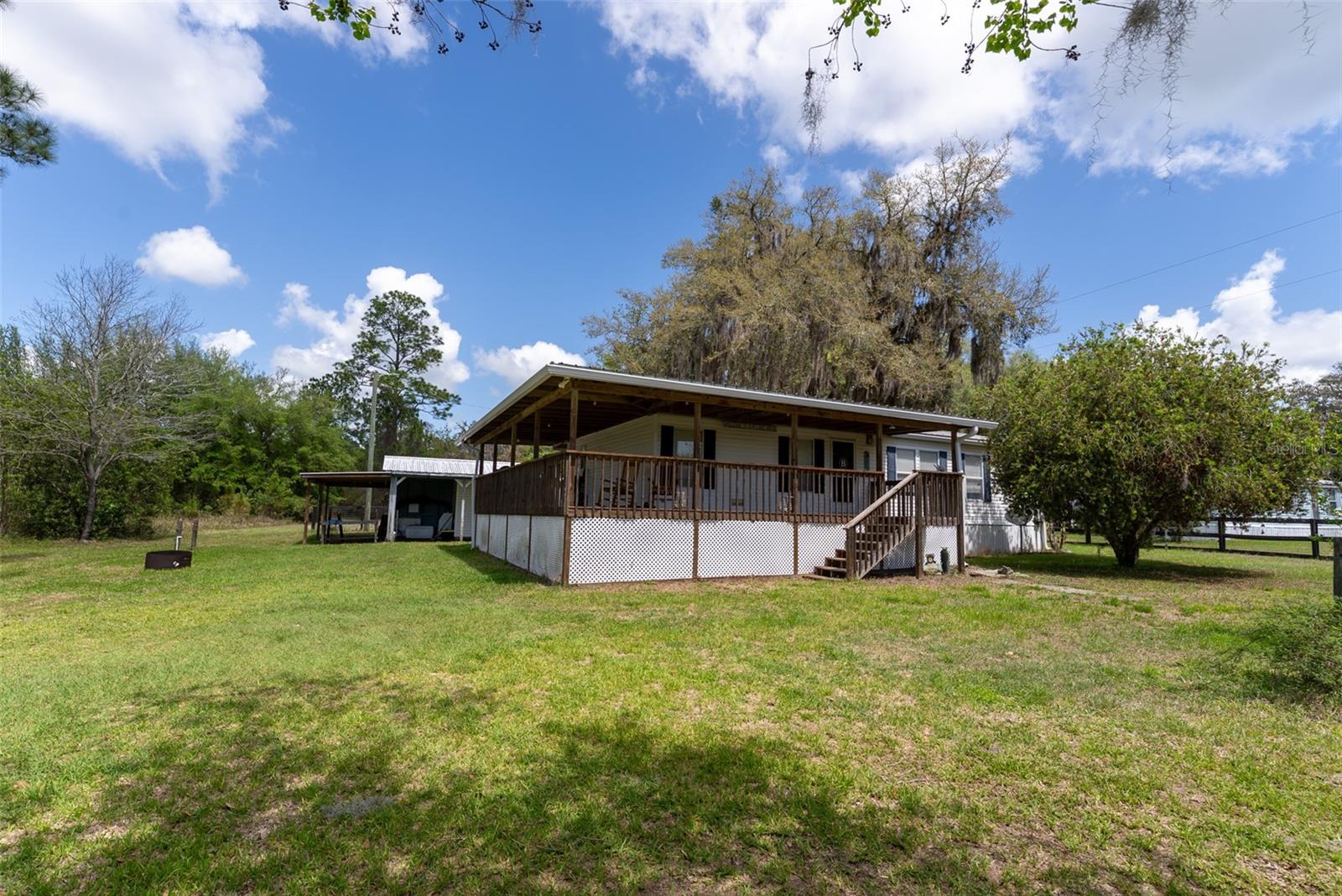 Tucked away in the heart of nature, this beautifully reimagined retreat is the kind of place you have to experience to truly appreciate it! Surrounded by the peaceful wilderness of the Ocala National Forest, this fully upgraded 2- bedroom, 2-bath split-plan home offers the perfect balance of comfort, privacy, and outdoor adventure.  Step inside to a warm, cabin-inspired interior where every detail has been thoughtfully renovated to create a cozy yet modern escape.  The spacious layout features a generous primary suite with a private bath and walk-in closet, along with an inviting living area anchored by a charming wood-burning fireplace---perfect for relaxing after a day outdoors.  But the real showstopper? An expansive wraparound deck that stretches from the front to the side of the home, designed for entertaining, grilling, or simply soaking in the serene surroundings.  Start your mornings with coffee on the porch, unwind with evening stargazing by the firepit, and enjoy uninterrupted views and total tranquility.  Outdoor enthusiasts will love the proximity to Lake Buckskin, as well as nearby Lake George and Lake Kerr. With endless opportunities for fishing, boating, kayaking, ATV riding, and exploring trails, adventure is always just minutes away.  Salt Springs is only a short drive for everyday conveniences, while Palatka offers additional shopping and dining options.  Whether you're looking for a private getaway, a full-time residence, or an income-producing Airbnb, this off-grid oasis delivers a rare blend of seclusion and accessibility.  It's more than a home---it's your gateway to the ultimate Florida outdoor lifestyle.