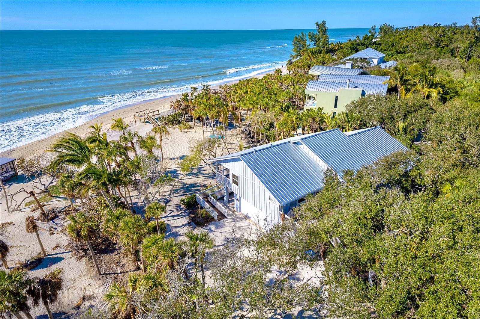 <p>Beachfront Oasis on Manasota Key - Your Tranquil Paradise</p>
<p>Nestled within the natural beauty of Manasota Key, Florida, lies an exceptional coastal estate, capturing the essence of luxurious beachfront living. This private retreat, located in Sarasota County, is situated on a 0.8421-acre lot with 125 feet of beach frontage. </p>
<p>The old Florida charm of Manasota Key’s designated canopy road leads you to the property’s lush vegetation and breathtaking gulf views. Oak trees and tropical palms grace the property, providing a peaceful, shaded sanctuary. 
<p>This 3-bed, 2 ½-bath home seamlessly blends indoor and outdoor living, immersing you in the coastal lifestyle. Wake to the sound of waves and seabirds from the master suite, with sliding glass doors opening onto the balcony and its stunning beach views. </p>
<p>At the heart of the home, discover a newly remodeled gourmet kitchen featuring stainless appliances and custom cabinetry. The spacious bar is ideal for entertaining family and friends. </p> 
<p>Living areas are thoughtfully designed with an open floor plan, boasting high ceilings and abundant natural light. Expansive windows and sliding glass doors connect the interior to the verdant lawn and magnificent Gulf of Mexico views. </p>
<p>On the ground level, a spacious garage provides ample room for vehicles and water toys. An air-conditioned game room/flex space offers endless possibilities for fun. This versatile area could be used for game tables, a quiet retreat, storage, or as overflow space for guests, ensuring their comfortable stay. </p>
<p>Outdoors, the allure of the Gulf of Mexico beckons. Stroll down the shell path through tropical foliage, shaded by coconut palms and sea grapes to your own sandy shoreline. Enjoy the day in a hammock with a good book, join your family for lawn games, or cast a line to the many snook, tarpon, and redfish that cruise the surf. Wrap up the day watching a spectacular sunset from the beachside deck. Moments spent from sunrise to sunset in this coastal haven become cherished memories. </p>
<p>This beachfront home invites you to experience the best of Florida's Gulf Coast. Seize this rare opportunity to own a piece of paradise. Contact us to embark on your journey to coastal enchantment today. </p>