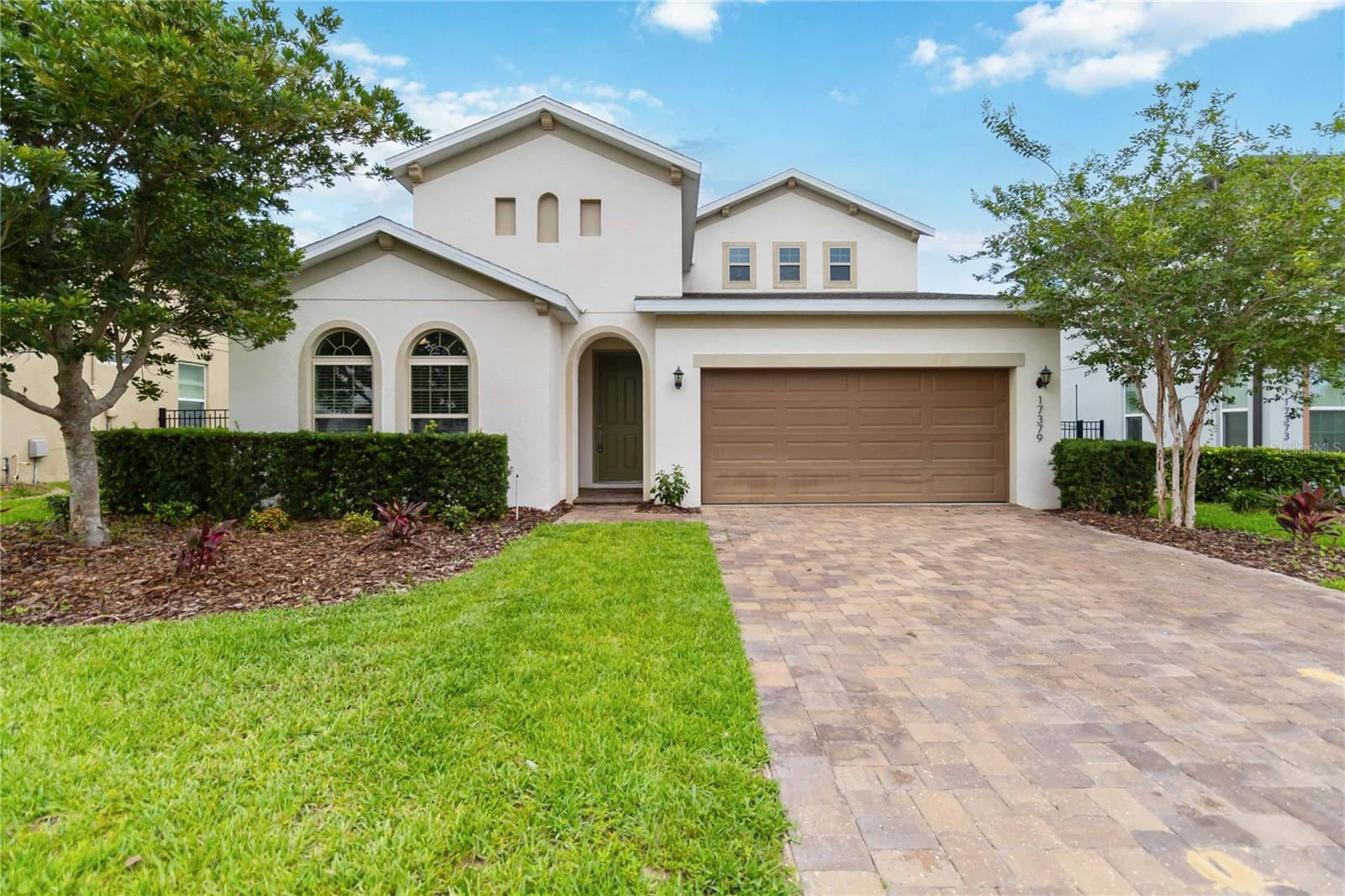 Large 4-bedroom home + 2 large Bonus rooms. This 2782sf 7-year-old home is in the awesome community of Lakeside just west of the Winter Garden Village about 4 miles. The home has tons of space, humungous kitchen and Master bedroom downstairs along with bedroom #2 and 3, and with a full bath. The first floor is gorgeous tile from the front door throughout up to the bedrooms. Coffered details in high ceilings, arched openings and a back yard looking over a green retention area. This Hampshire plan has a split plan with 2 bedrooms and full bath near the front of the house first floor. Walking past the flex room that can be used for formal dining, office, etc to the main open living area with living, dining, and kitchen. The kitchen is large with TONS of tall 42 inch raised panel cabinetry and walk-in pantry. The beautiful light brown speckled granite is accented by medium Brown cabinets and all stainless-steel appliances with the stove fueled with gas. A walk-in pantry and Island sink with breakfast bar look out to the open living room and dinette. Dinette has large windows on 3 sides to embrace the outside nature. The main living area has a 3-panel slider door to open wide to the paved, covered Lania that overlooks a good-sized back yard with a large field retention area beyond. Past the living room through the arched entry into the large primary bedroom. Ceiling fan and high coffered detailed ceilings and a huge bath with a seated walk-in shower separating two individual vanities on large cabinets for lots of storage. Large walk-in closet, separate toilet room, and linen closet. Washer and dryer have their own room near the garage. Take a quick step upstairs to a HUGE open loft, 4th bedroom and 3rd full bath. full bath. This home has a 2 car garage and gas heated Tankless water heater. This home is located in the awesome community of Waterside at Johns lake, with an incredible huge pool lakeside, playground, dock, clubhouse, state-of-the-art fitness center