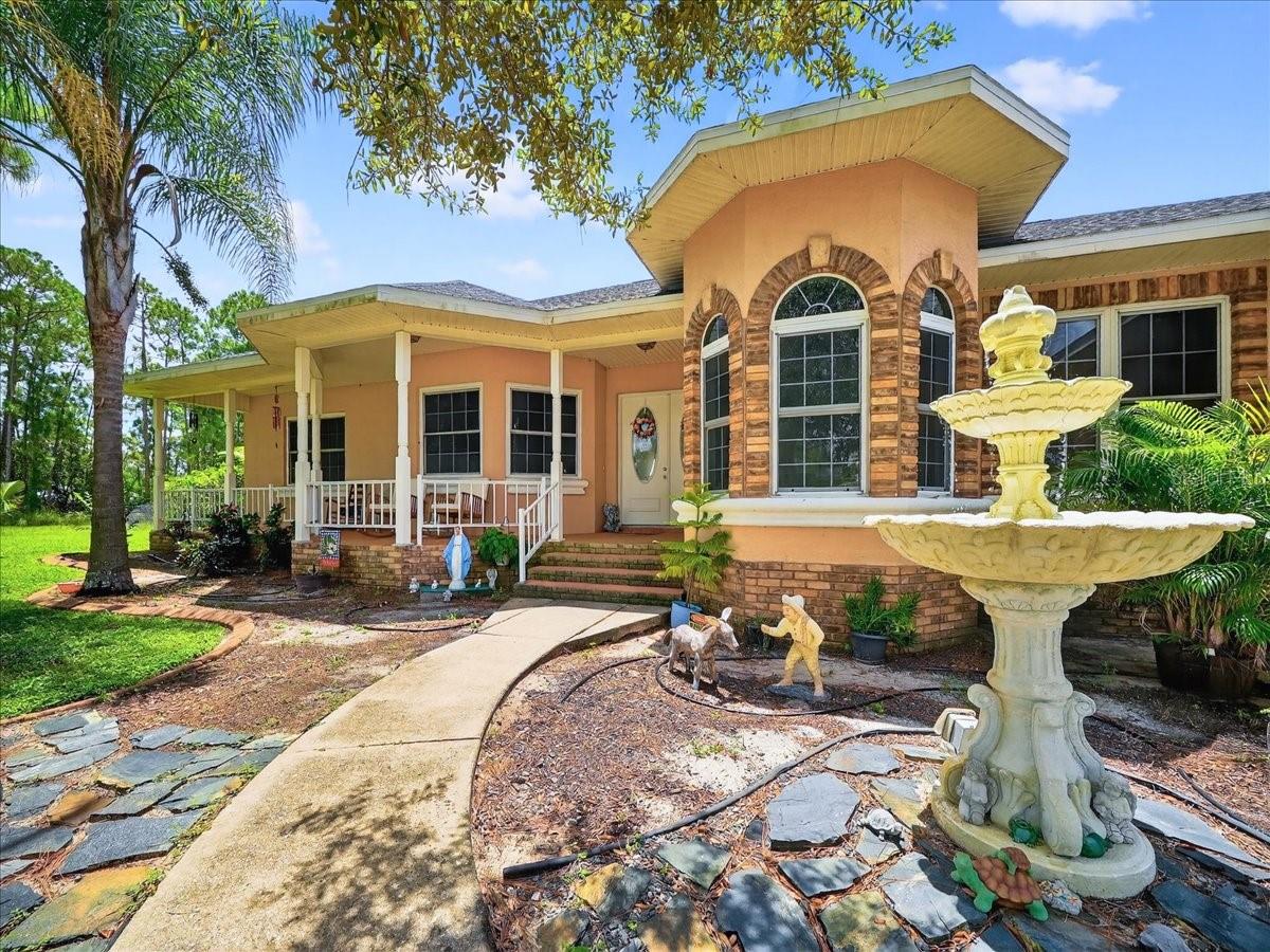 Up to $10,000 closing costs assistance offered by seller. Welcome to this beautiful custom lakefront home on Lake Keys offering 2,907 sq. ft. of living space and 4,266 total sq. ft. designed for comfort, functionality, and stunning waterfront living. 2025 Roof, 2023 HVAC, Septic Serviced 2025. Situated with no HOA, this property features an impressive 120×28 driveway capable of accommodating multiple RVs, boats, or recreational vehicles, along with an oversized 2 car garage providing exceptional storage and workspace. Inside, the home showcases real hardwood flooring throughout, custom volume and coffered ceilings, abundant natural light through elegant glass doors, and an open, airy layout centered around a striking fireplace. The gourmet kitchen is equipped with high-end stainless-steel appliances, granite countertops, and custom cabinetry, ideal for everyday living and entertaining. Enjoy outdoor living year-round with covered front and rear patios, outdoor kitchen hookups, and a spacious wooden deck extending toward the lake with beautiful water views. The property includes a quality private well with advanced filtration, while newly installed public water access is available across the street for future connection. A one-year home warranty adds additional peace of mind, making this exceptional lakefront residence a rare opportunity to enjoy space, flexibility, and scenic Florida living.