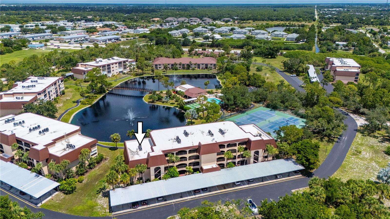 Perfectly positioned end unit overlooking the lake, this condominium offers peaceful water views, exceptional privacy with no unit above, and an abundance of natural light. From the moment you step inside, your eyes are drawn through the open living and dining areas to the screened lanai, where tranquil lake views, a sparkling fountain, and colorful sunset skies create the perfect setting to unwind at the end of the day. Designed for comfortable everyday living, the open floor plan features a spacious living and dining area connected to the updated kitchen by a convenient pass-through window over additional cabinets for storage, creating an inviting space for entertaining or enjoying quiet evenings at home. The kitchen has been refreshed with updated countertops and backsplash, while recent improvements throughout the home include new carpet, fresh interior paint, baseboards, and storm shutters in 2023. Additional upgrades provide peace of mind, including a new A/C system and electrical panel in 2022, a water heater in 2021, and a new community roof. The primary suite offers a walk-in closet, and a private en-suite bath. A full-size washer and dryer are conveniently tucked into the interior laundry closet hallway, making everyday living effortless. Existing Furniture/furnishings convey with purchase. Located within the gated waterfront community of Rolls Landing, residents enjoy direct access to Charlotte Harbor and the Gulf of America along with an exceptional collection of resort-style amenities. Spend your days fishing from the newly rebuilt 300-foot pier, launching your kayak, taking advantage of first-come, first-served boat slips, or relaxing beneath the waterfront tiki hut while watching spectacular Florida sunsets and abundant wildlife. Additional amenities include a heated pool and spa, fitness center, tennis and pickleball courts, shuffleboard, bocce ball, clubhouse, library, walking and biking trails, community garden, fire pit, gas grills, boat and vehicle wash station, dry boat storage, and 24-hour guarded entry. Just minutes from historic downtown Punta Gorda, waterfront dining, boutique shopping, farmers markets, golf courses, Gulf beaches, Interstate 75, and Punta Gorda Airport, this exceptional residence offers the perfect blend of comfort, convenience, waterfront recreation, and effortless Southwest Florida living.
