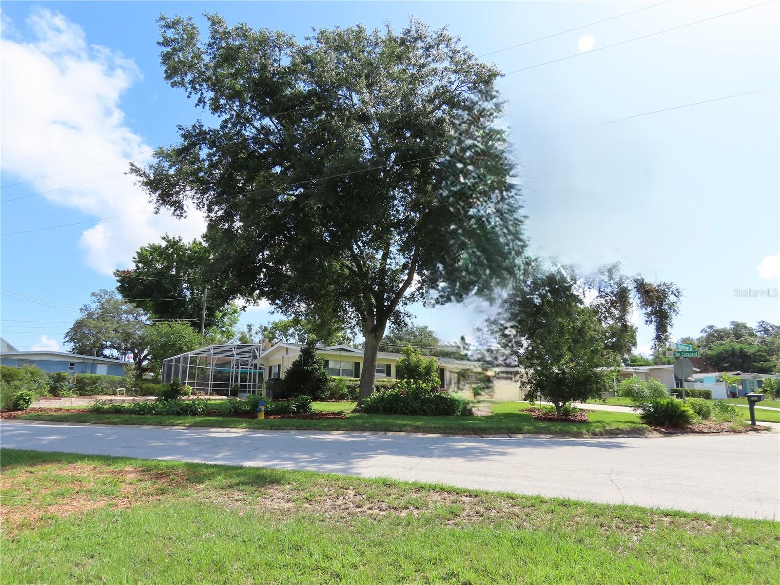 Unique Pool/Spa Home on corner lot set up as either a 3br/1.5 with attached 1br/1ba in-law suite fully equipped with its own entrance, courtyard and carport or possibly 4br/2.5bath home all in a perfect central location. NO HOA. Bring your water toys, boat or RV. Deeded 1/119th interest ownership to Lake Minnehaha Chain of Lakes private beach which includes pavilion, dock and boat ramp. Enjoy watching the sunset or fishing from the private pier, launch your boat from the ramp, and explore the beauty that Clermont Chain of Lakes provides.  The 2009 remodeled Kitchen is equipped with all appliances, granite counter tops, moveable island, hickory cabinets, breakfast bar and tile floors. Energy efficient on demand natural gas tankless water heater. Living room, dining room and first bedroom/office have beautiful acacia hard wood floors. Large family room with sliding glass doors that offers tranquil views and access to your salt system pool. The recently resurfaced pool and updated tile border is a beautiful upgrade. The generous size pool deck features a summer kitchen with built in natural gas grill w/rotisserie, sink, counter, and bar top. Relax and listen to the soothing sounds from the rock waterfall or soak in the hot tub all within a screen enclosure. Gas heater for both pool and spa along with the variable speed pump will allow you to enjoy year-round fun. Automatic 6 zone irrigation system. The dog run features easy clean pet turf and a sunshade, providing comfort and protection for your pet or use it as an extended area for entertainment.  The backyard is ready for the hobby gardener with a greenhouse, 5 raised beds, drip irrigation, trellis for vertical plantings, 2 rain barrels and a storage shed. The west side of this property lined with native shrubs attracts many songbirds and offers privacy for parking your RV (or boat, 2 cars, you choose) on the gravel driveway where you can conveniently hook up to water and 30-amp electricity. There are a variety of fruit trees (mango, avocado, plum, cherry, jaboticaba, kumquat) and pineapples to nibble on. This unique home and property with NO HOA are truly a rare find with so much to appreciate and only minutes to Historic Downtown Clermont, shopping, schools, banks, Florida Turnpike - you name it! Don't miss out on building a lifetime of memories in this wonderful place to call home!