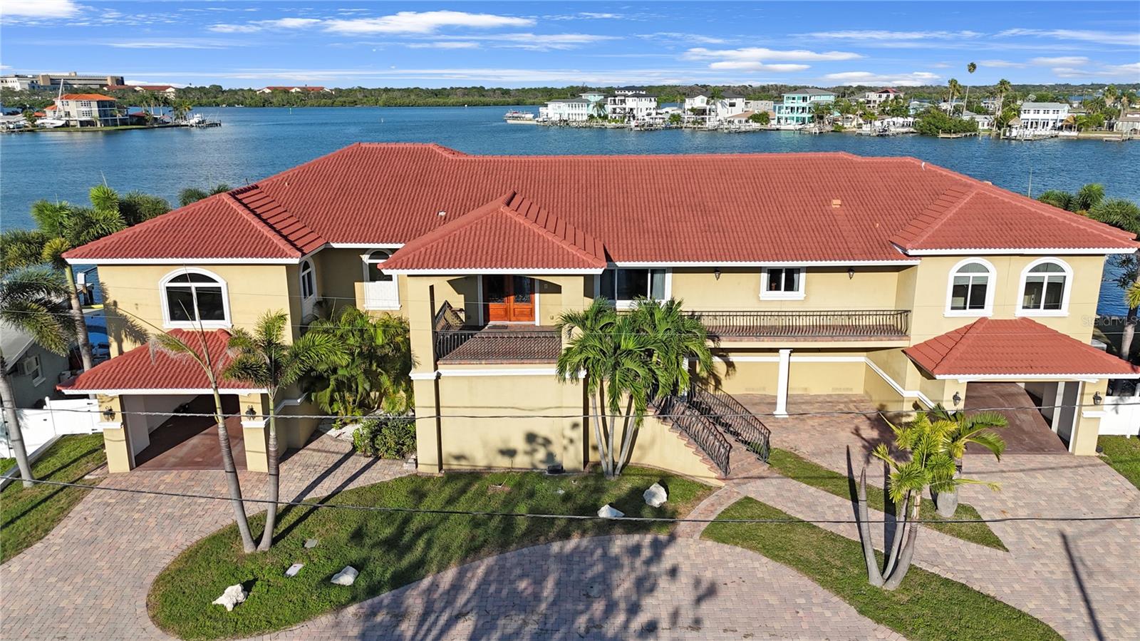 Welcome to one of the most unique and desirable waterfront properties in Madeira Beach. Situated on a massive 13,500+ square foot lot with 145 feet of water frontage, this estate offers an unparalleled opportunity for boaters, water lovers, and those seeking true Florida luxury. Waterfront lots of this size are extremely rare, and with direct access to the Intracoastal Waterway, you will enjoy quick and easy boating to the Gulf of Mexico. The oversized dock can accommodate nearly any size vessel, making this a dream setup for yacht owners and avid boaters alike.

The main residence, built in 2009, features 3,750 square feet of heated living space with five spacious bedrooms and four full bathrooms. Designed with both comfort and elegance in mind, the home boasts high ceilings, abundant natural light, and modern upgrades throughout. Inside you will find a stunning open floor plan with hardwood and tile flooring, a welcoming foyer with grand double entry doors, and a living area that opens up to breathtaking waterfront views. The chef’s kitchen is complete with rich wood cabinetry, granite countertops, stainless steel appliances, a large center island, and pendant lighting, making it ideal for entertaining.

Additional highlights include an expansive waterfront balcony stretching the full length of the home, a durable tile roof, a ten-car garage providing incredible storage or car collection space, a private elevator for convenience and accessibility, and a spacious laundry room. The elegant entry staircase enhances the home’s curb appeal and sets the tone for the luxurious living within.

Out back, the property offers ample room to relax, entertain, or simply take in the serene waterfront lifestyle. The oversized lot also provides opportunities for future expansion, outdoor living enhancements, or the addition of a custom pool overlooking the canal. This home truly combines the best of Florida living with a rare oversized lot, premier waterfront access, and a modern, spacious home. Ideally located just minutes from the sandy beaches of Madeira Beach, top-rated dining, shopping, and vibrant entertainment options, this property offers the perfect balance of privacy and convenience.