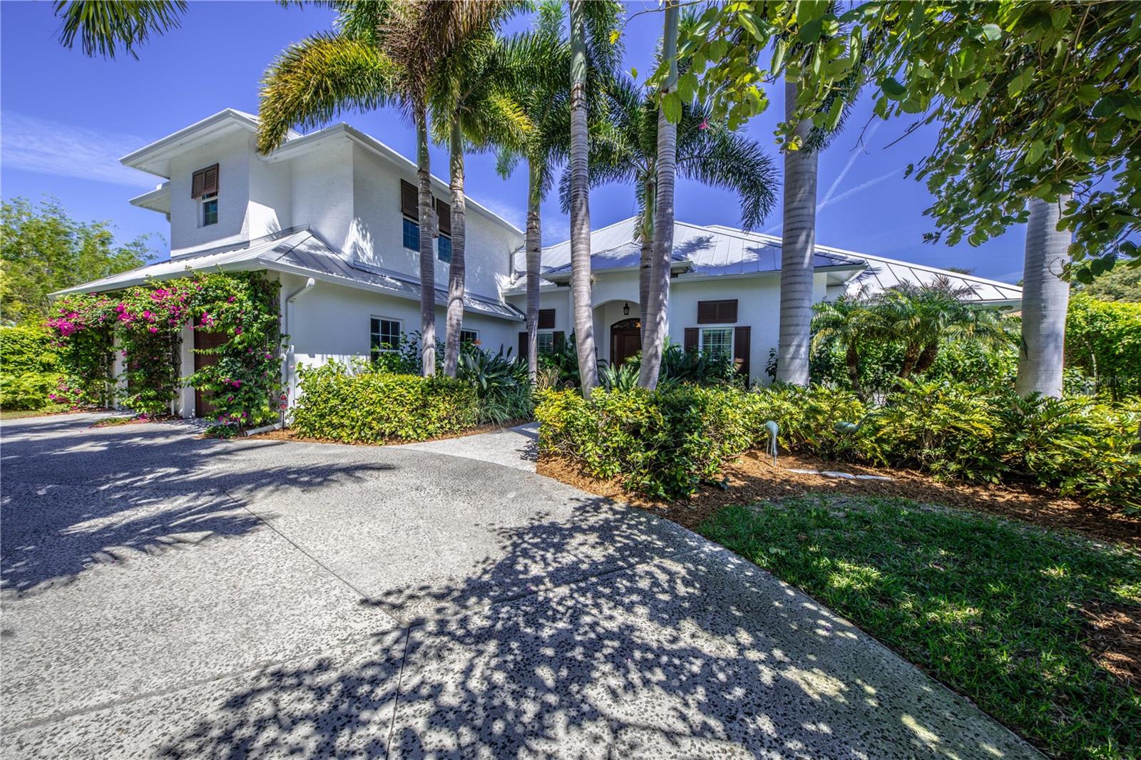 Custom home built by a Boca Grande builder, in sought after location that blends tradition with in-town Venice tropical and beach vibe lifestyle. This unique, carefully crafted Venice Island home features 4 bedrooms, 4.5 baths, all with ensuite bathrooms. Bedroom 3 is a very large bonus room above the garage and has been described as a tree house. This bedroom or office has an ensuite bath and its own A/C system. Spectacular old Florida palm trees and carefully curated plantings include hedges for the ultimate in lush tropical privacy. This home was a favorite in the annual home and garden tour. The home highlights include custom built-ins, extensive mill work, and travertine and wood floors.  Magnificent honeysuckle on a custom arbor is located at the entry to the pool area. Lush flowers include white birds of paradise, flower hedges and more making this home a birder and gardener’s paradise. Enter the home through the bespoke 42-inch x 8 foot mahogany door that leads the way to 15 foot tray and coffered volume ceilings and the vista to the pool and plantings beyond. A real “cook’s kitchen” which includes a 48-inch Wolf dual-fuel stove with 6 burners and griddle with a 54” exhaust hood. The white Carrera marble island is 90” long by 65”.  There is an additional prep sink in the island. Also includes Subzero refrigerator, Viking microwave, Bosch dishwasher, and a U-Line icemaker and prep sink in the spacious butler’s pantry. Custom tilework throughout the house. Primary bath features dual sinks, Carrera marble and walk-in shower and a separate soaking tub. Outdoor shower, grill area and screened pool areas make this home the perfect place for entertaining.  A cozy light-filled library with custom bookshelves and mahogany floor welcomes avid readers. A poolside casita was especially designed with privacy and relaxation in mind. Walking distance to Venice—the quintessential and historic beach community! Walk or bike ride into our quaint downtown, beaches, the Jetty and more! 
One of the owners is a Florida licensed real estate agent/broker. Bedroom Closet Type: Walk-in Closet (Primary Bedroom).