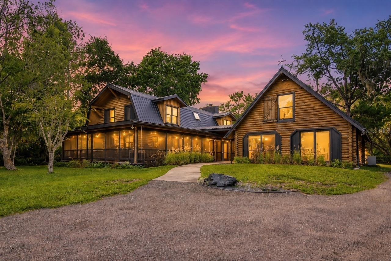 Paradise awaits!! Don't miss the opportunity to own this one of a kind hi and dry 1.86 acre property , tucked away on a private gated dead end street with only 5 other homes and deeded private 5 acre park with boat ramp access to Lake Monroe and St. John's River! Located in the gorgeous community of Stone Island, this property has a main residence and guest residence perfect for extended family and guests! The main house is a 3 bed 2 bath log cabin with 30' ceilings and huge master upstairs! Timeless brick and wood floors throughout. Large open kitchen for family gatherings and entertaining. Recent upgrades by current owner include new plumbing, custom bathroom with beautiful hand carved rock work facade , new vanity, new flat roof on porches, new coating on metal roof, paint interior/exterior, tankless hot water heater and much more! On the rest of the property you will find beautiful century old manicured oak trees and bamboo! There is a 2000 sq ft custom metal building with a custom bar/saloon and bathroom to entertain guests! Building has completely insulated walls and ceilings with custom hand burnt siding which took hundreds of hours to complete! Building can also accommodate multiple vehicles or boats for storage. This is truly a man cave on another level! There is also an adjacent pole barn/work shop with an added bathroom. All of this leads down a private milled pathway to a deeded 5 acre park and boat ramp leading to lake Monroe and St. Johns River! Make an appointment to see this one of a kind property today!