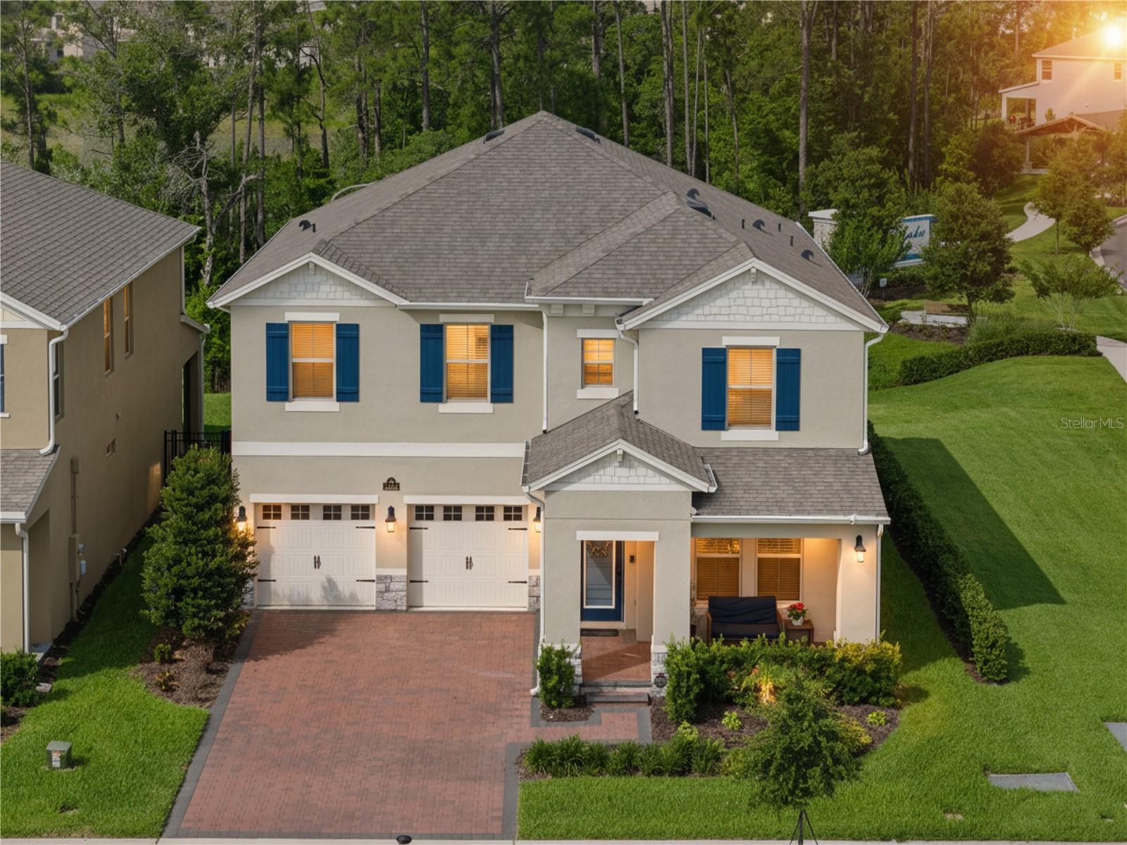 PREMIUM LOT with CONSERVATION VIEWS!   Enjoy this popular TORREY Floor Plan with 5 Bedrooms, 4.5 Baths, Large LOFT with CUSTOM Built-In Fireplace, Oversized Covered Patio with Electronic RETRACTABLE Screens and a FENCED YARD next to EXTRA GREEN SPACE and surrounded by OVER 7 ACRES of Conservation just minutes from DISNEY!    The Beveled Glass Front Door Welcomes you into a Home filled with ALL THE BEST UPGRADES!  Wood Plank Porcelain Tile Floors, FLEX Space that can be a Dining Room or Office.   CUSTOM Painted Interior Doors with Matte Black Hardware.  The GOURMET Kitchen features White 42” CABINETS with Crown Molding, QUARTZ COUNTERS, Upgraded Tile BACKSPLASH, Large ISLAND and SS APPLIANCES including a 5 Burner Cooktop with Vent Hood and Built-In Oven and Microwave Combination.   Plus a Butler Pantry with EXTRA CABINETRY and a Large Pantry provide Lots of STORAGE!   Sliders from the Family Room open to the Covered Patio with Ceiling Fans, Retractable Screens that also BLOCK UV Rays and Extended Paver Patio great for Container Gardening or a Fire Pit!  This PRIVATE Backyard is where you will want to have your Morning Coffee or Host Evening Get Togethers!  The First Floor includes Bedroom 5 with Tile Floors located next to FULL Bath 4.  A convenient Powder Bath completes the 1st Floor.    Wood Stairs with White Risers lead to the LOFT with CUSTOM Built-In Cabinetry with Stacked Stone Wall, Wood Mantel, Abundant Shelving and Stylish ELECTRIC FIREPLACE!   The Primary Bedroom has a Tray Ceiling and Opens to a Bath with Upgraded Cabinets, Long Counter with DOUBLE SINKS, Garden Tub, Shower with Shampoo Niche, SEAMLESS Shower Door, and Upgraded Tile to the Ceiling.  The WALK-IN Closet is over 12 Feet Long!   In this Split Plan, Bedrooms 2 and 3 share Bath 2.   Bedroom 4 has an Ensuite PRIVATE Bath 3 with Upgraded SHOWER instead of a tub.  The Laundry Room is Pre-Plumbed for a Utility Sink and Includes the Washer and Dryer.  Great Features Include: Upgraded Porcelain WOOD PLANK TILE throughout First Floor and Baths, Ceiling Fans, Wood Stairs with WROUGHT IRON Spindles, GUTTERS and a Whole House Water FILTRATION System.   This Energy Efficient ALL BLOCK Home saves $$ on Utility Bills with Double Pane “Lo E” Windows, Reclaimed Water for Irrigation and R-30 Insulation and 15 Seer Carrier AC Unit.   Located in WATERLEIGH – the PREMIER LIFESTYLE COMMUNITY in the area with 4 Community Pools, 3 Clubhouses and Fitness Centers, Fishing Pier, Playgrounds, Parks, Sand Volleyball, Tennis, Pickleball and MUCH MORE!  RELAX and enjoy your home – HOA does all Yard Work!  All this close to DISNEY, DINING, SHOPPING plus Water Spring Elementary and Water Spring Middle Schools are in walking distance and zoned for the NEW Horizon High School!  Easy Access to 429, 417 and 408!