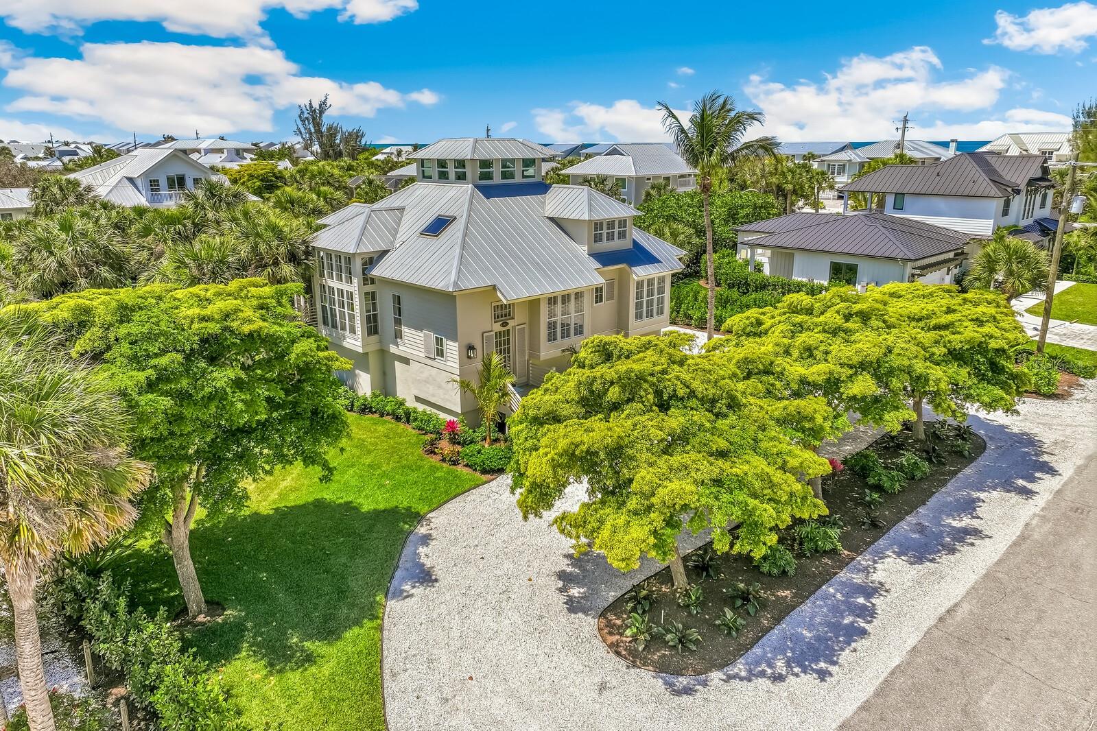 Welcome to 312 Baily St — a charming 3-bedroom, 3-bath home in the Golden Beach neighborhood on the south end of Boca Grande, just one block from the Gulf of Mexico. Built in 2003, this custom 2,572 sq ft home offers an open floor plan with a third-level bonus room featuring expansive island views. Inside, vaulted ceilings, hardwood floors, oversized windows, and a skylight bring in natural light throughout, with a tucked-away reading nook for relaxed afternoons. The kitchen offers a gas cooktop, ample counter space, and a breakfast bar for casual meals and gathering. The primary suite includes a private deck, office space, and a spacious bath with soaking tub, walk-in shower, and double sinks. A large screened porch overlooks the oversized, beautifully landscaped lot, offering a private, quiet setting. A three-car garage provides ample space for vehicles, golf carts, storage, and beach gear, so parking is never a concern. This property boasts concrete block construction at the ground level, along with an elevated structure, Hardiplank siding, and a metal roof for lasting durability. Close to the beach, the village of Boca Grande, the lighthouse, and the Gasparilla Inn & Club, the property’s location makes it easy to enjoy everything the island has to offer. Nearby amenities include pickleball and tennis courts, a local farmers market, and a dog park. Comfortable coastal living in one of Boca Grande’s most desirable neighborhoods. Don’t miss your chance to call Boca Grande home.