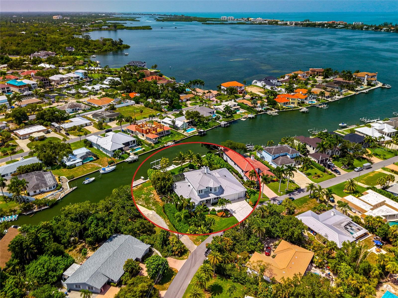 Imagine having your own private outdoor paradise designed for a relaxing life on the water. This custom designed Key West style residence in Southpointe Shores offers deep sailboat water on a rare wide natural bayou with more than 100 feet of waterfront, complemented by a new Atkins seawall, a 30 foot Cool Touch dock, a 27,000 pound boat lift, second wet slip capability, and a fish cleaning station.

Built by Graber Homes and extensively and beautifully renovated, the residence features an open floor plan with living and dining areas that transition naturally to the kitchen and waterfront. Renewal by Andersen sliding doors frame the canal and provide direct access to the outdoor living spaces. Travertine flooring extends throughout the entire first level.

The kitchen includes fine wood custom Campbell Cabinetry, Calacatta marble countertops and backsplash, a large entertaining island, a walk in pantry, and gourmet appliances featuring a new Sub Zero refrigerator, a Wolf wall oven, two Miele dishwashers, a Wolf coffee station, and a 48 inch Fulgor Milano induction range.

Additionally, the first floor offers a roomy primary suite with two walk in closets and an updated Campbell Cabinetry bath with dual vanities, a walk in shower, and a clawfoot tub, along with a pool bath and an oversized laundry room.

The second level offers three guest bedrooms, a full bath with a marble walk in shower and Campbell Cabinetry, and a large bonus room currently arranged as a home gym. New wood look tile flooring extends throughout the second floor.

Outdoor spaces include a 7 foot deep saltwater pool and deep seat gas heated spa, a built in 48 inch Lynx outdoor kitchen, professionally designed Artistic paver patios and walkways, a gas fire pit in a private seating area, a second patio for sunbathing, and a stunning landscaped pond with waterfalls inspired by Marie Selby Botanical Gardens. The home also features a 14 speaker indoor and outdoor NHT sound system for entertaining.

The entirely fenced backyard provides privacy with direct access to the dock and waterfront.

Recent improvements include a whole house 26KW Generac generator, three new Bryant HVAC systems with new ductwork and Knauf insulation, an Aprilaire whole home fresh air and dehumidification system, whole house water filtration, new Starlink internet, two 48 amp Tesla charging stations, and a large air conditioned three car garage with hanging rack storage along the ceiling.

Located West of the Trail, Southpointe Shores offers a friendly optional HOA, a private gated neighborhood boat ramp and park, and easy access to Midnight Pass, Sarasota Bay, Siesta Key, downtown Sarasota, shopping, and dining.