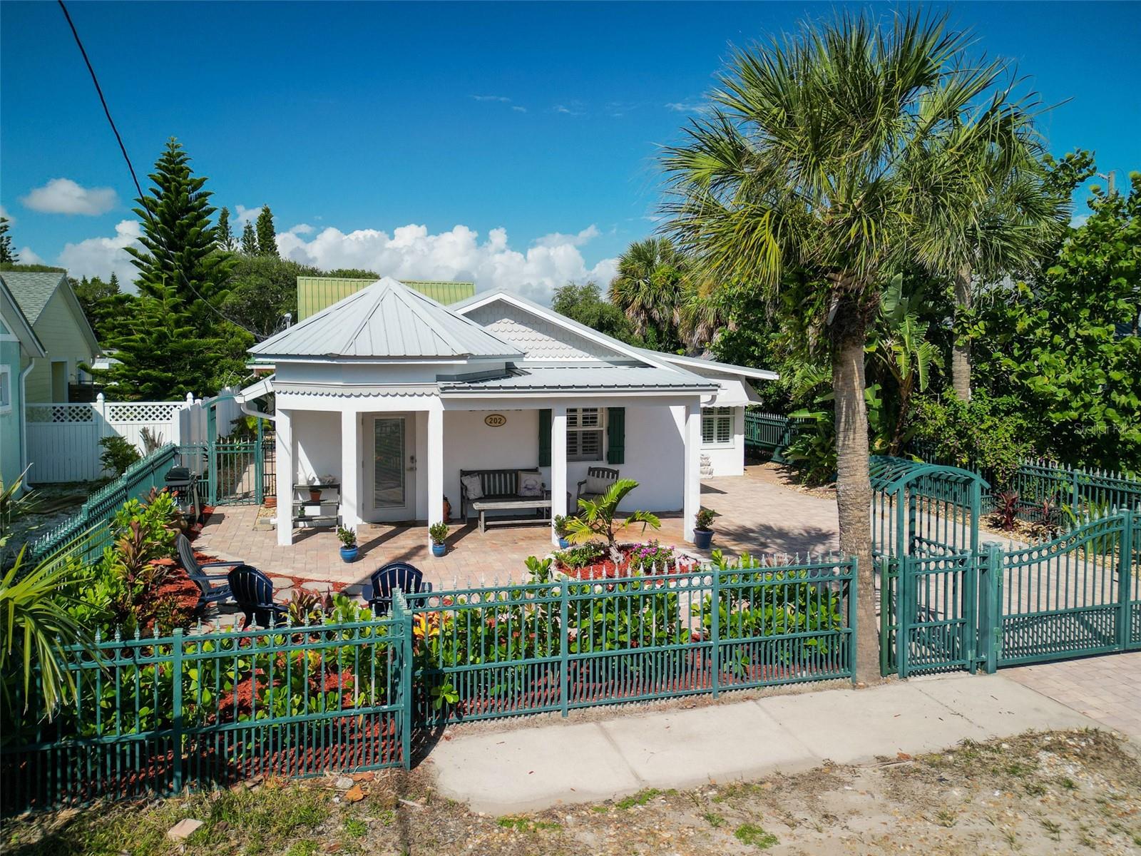 Discover the perfect blend of charm and convenience in this delightful beach bungalow, ideally located just steps from the lively shops and restaurants of Flagler Avenue and a short stroll to the sand and surf of New Smyrna Beach. Featuring 3 bedrooms, 2 bathrooms (one hot/cold shower is enclosed outside), plus a finished, under-air outbuilding - perfect for a studio, office, or guest suite, this home offers both comfort and flexibility. The open-concept layout creates an inviting space for entertaining, while the light and airy beach vibe makes every day feel like a getaway. Enjoy easy living with a low-maintenance, fully-gated yard, paver driveway and an enclosed/paver back patio, metal roof, and storm shutters—all designed for peace of mind and convenience. Advantageously located in the bed and breakfast overlay district, this property has also generated a steady rental history. Whether you’re looking for a full-time residence, vacation retreat, or investment property, this home truly has it all.