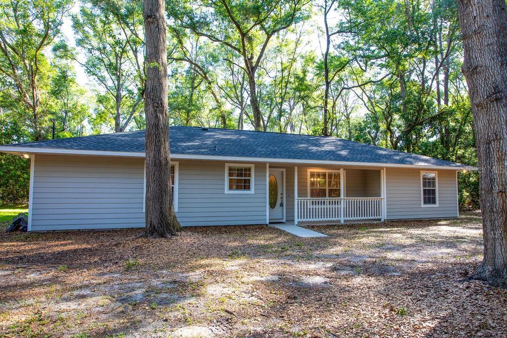 This 3 bedroom, 2 bathroom home sits on 5.01 acres. It includes a split floor plan, updated finishes, wooded land, and a large two-story barn. If you want a move-in ready home with acreage, privacy, and room to do more, this property delivers. The home has been updated with LVP flooring throughout. The kitchen is large with real workspace. There is a separate laundry room. The split floor plan puts the master bedroom on one side and the two secondary bedrooms on the other, giving everyone their own space. The master bedroom is large and includes a big walk-in closet and a private full bathroom. The two secondary bedrooms are also larger than average and share the second full bathroom on their side of the home. The entire 5.01 acres is in Flood Zone X, which is the lowest risk flood designation. The home sits at the front of the property with wooded land behind it. The woods are full of deer, turkey, and other game, making this a solid setup for any hunter who wants their land right out the back door. The two-story barn is one of the biggest features on this property. It works as a two-car garage, a shop, or it could be finished into a guest home or secondary living space. The size and layout give you options now and down the road. There is no HOA. You use the land the way you want. Location is strong. High Springs is less than 5 minutes away. Newberry is 18 minutes. Gainesville is 37 minutes with UF Health Shands and all the shopping and services of a major city. Lake City is 36 minutes in the other direction. You also have easy access to the Santa Fe River, Ichetucknee River, and some of the best springs in Florida just minutes away.