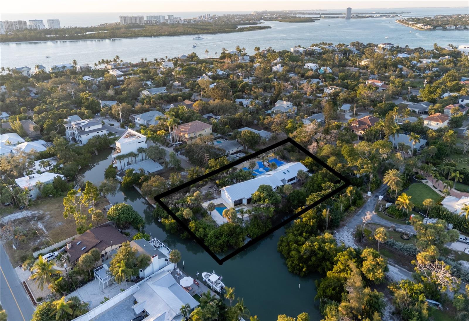 A Rare Opportunity on North Siesta Key with exceptional weekly income, prime location 350 Feet of Waterfront!

Discover this unique multi-family income producing single-story property on Bay Island, offering both beauty and potential. High and dry, the home remained unaffected by recent storms, with 4–5 feet of elevation to spare. Set on a tranquil, tropical lot, this historic location on Garden Lane—once home to the Siesta Key Fish Market—with easy fast access to the bay and Big Pass it is truly a boater’s and fisherman’s paradise. Just a few steps to Shell Beach and its breathtaking sunsets, minutes from the world famous Siesta Beach, Siesta Village with restaurants, shopping, nightlife, quick access to downtown, and St. Armands Circle. You have it all! 
The property features a classic Florida ranch-style 4-bedroom, 2-bathroom home with a pool, large deck, and lush backyard designed for entertaining, plus a detached 2-bedroom, 2-bathroom guest house. Whether you choose to renovate, rebuild, or divide the lot (buyers to verify with the City), the possibilities are endless with this property!