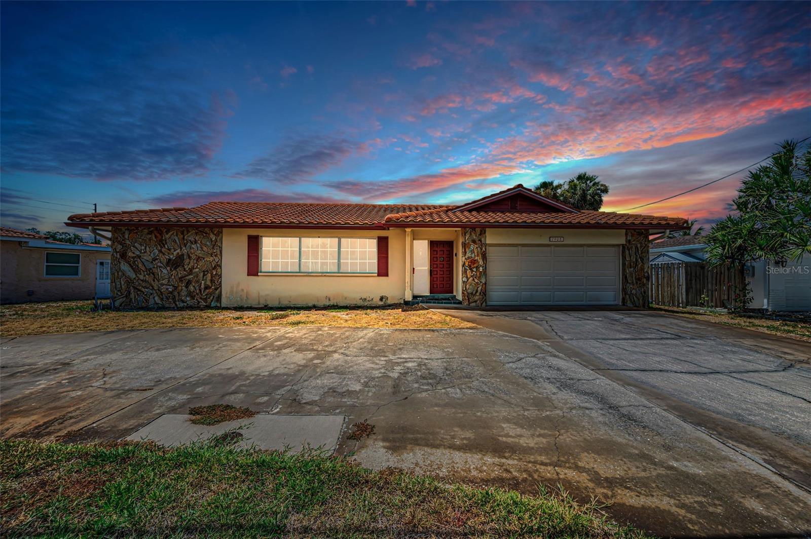 RARE OPPORTUNITY TO OWN A WATERFRONT POOL HOME AT ENTRY LEVEL PRICES!  This 4 bedroom, 3 bath, 2 car garage split bedroom floor plan features a large circular driveway, a spacious living room and a sizable family room that both open to the covered lanai and swimming pool area.  The owner’s suite opens to the pool deck and includes a walk-in closet and full bath.  A centrally located kitchen provides a breakfast bar and a passthrough to the covered lanai.  The 2nd bedroom opens to the lanai/pool deck, and has a full adjacent guest bath that doubles as the pool bath.  3rd and 4th bedrooms share a Jack and Jill bath, and the 3rd bedroom has water views.  Overlooking the swimming pool and waterfront, the lanai offers plenty of room for outdoor dining and lounging.  Swimming pool is operational and the seawall has been updated.  Located close to the beaches and less than a 15-minute drive to downtown St. Petersburg.  Dimensions are estimates, buyer to verify.