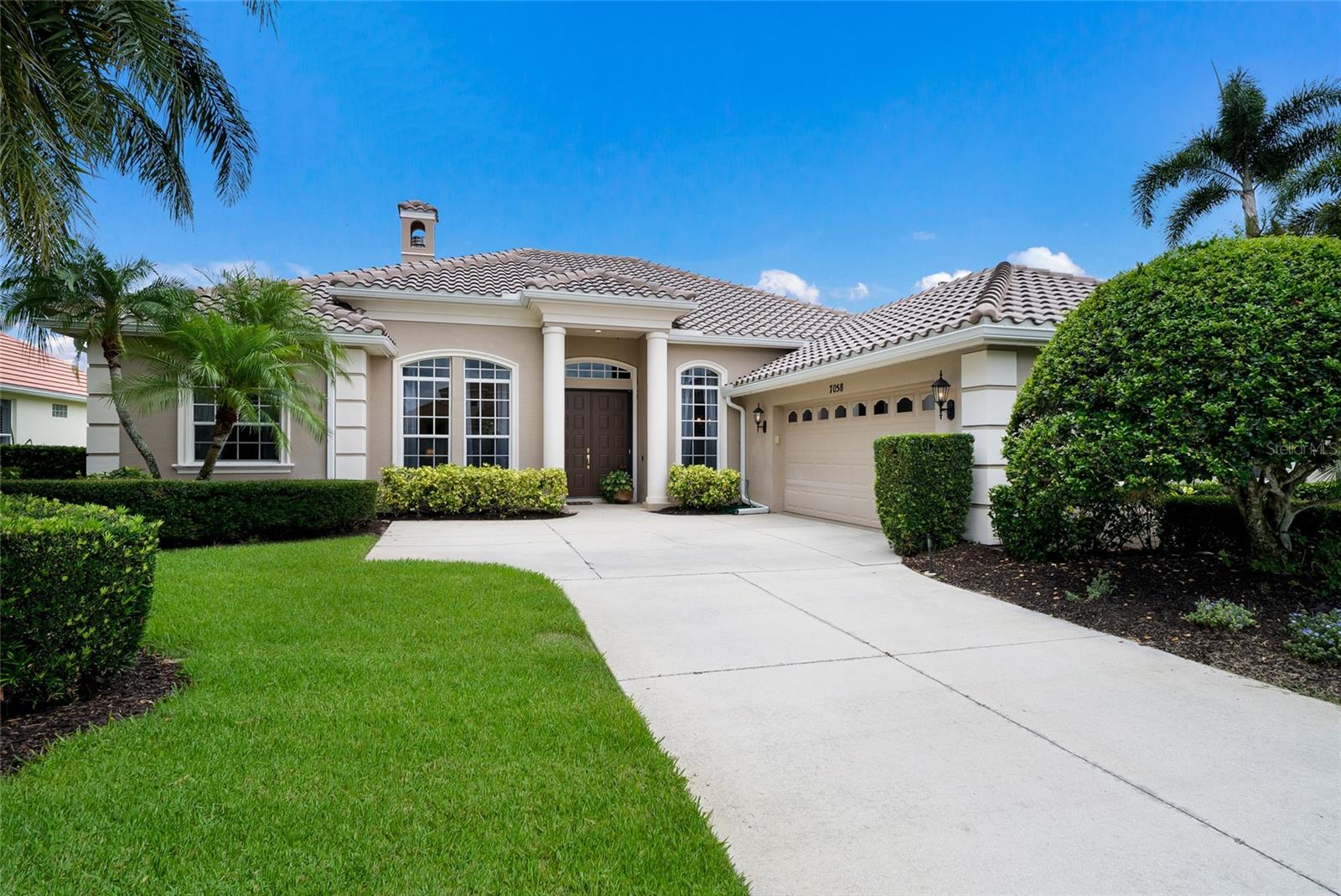Welcome to this beautifully maintained Todd Johnson-built home offering 2,604 square feet of elegant living space in the highly sought-after Lakewood Ranch Golf & Country Club. This exceptional residence features three bedrooms, three full baths, a private office, and a spacious two-car garage. The luxurious primary suite is designed for comfort and relaxation, featuring dual vanities, a dedicated makeup area, a large walk-in closet, new carpeting, crown molding, and sliding glass doors that open directly to the lanai. One of the guest bedrooms serves as a private en-suite, complete with its own full bath featuring a walk-in shower and walk-in closet.
Throughout the home, you'll find beautiful wood flooring, crown molding, a freshly painted interior, and thoughtful custom details. The inviting living room showcases built-in cabinetry and a cozy gas fireplace, creating the perfect gathering space. A charming dinette area overlooks the outdoor living space, while the dedicated office provides flexibility for working from home or additional living needs.
Step outside to your private Florida retreat featuring a stunning screened lanai and sparkling lap-style pool, resurfaced in 2022 with PebbleTec finish. Additional recent improvements include a new roof in 2025, new carpeting, and a newly finished epoxy garage floor.
Ideally located within Lakewood Ranch Country Club, this home offers the perfect blend of luxury, comfort, and timeless design in one of the area's most desirable communities.
The private Lakewood Ranch Golf & Country Club features 72 holes of championship golf across four courses, Three clubhouses with casual and fine dining options, resort-style heated swimming pools, fitness, group classes and personal training, tennis courts, pickleball courts, and a calendar of events.  Close to Sarasota and Tampa Airports, the finest beaches, downtown Sarasota, Waterside Place, UTC Mall.