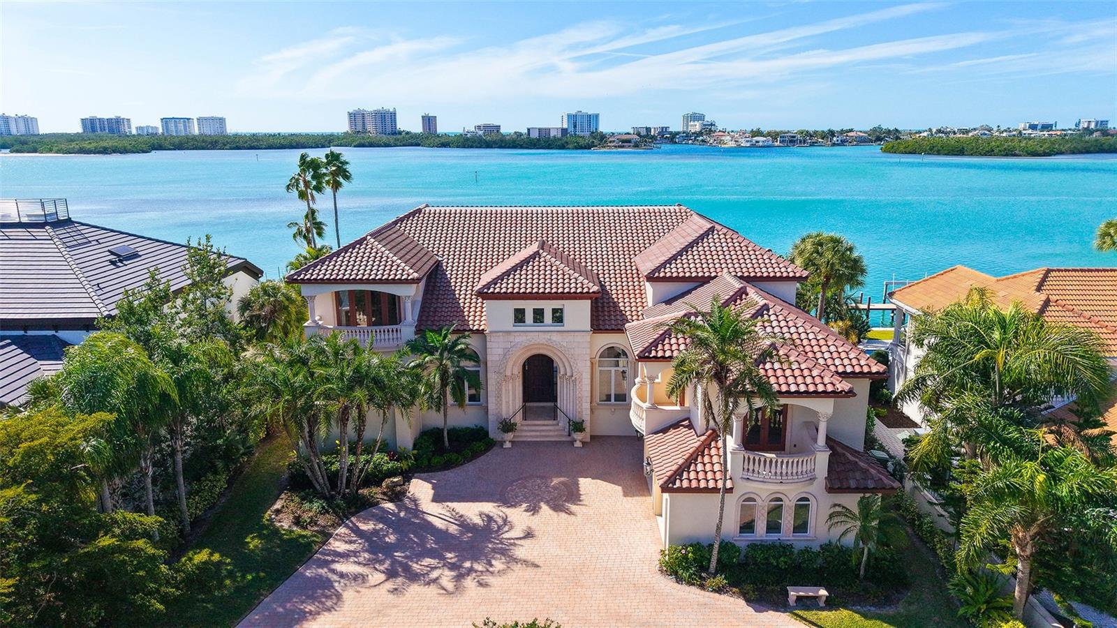 Welcome to an exceptional waterfront residence on coveted South Spoonbill Drive, where refined luxury meets Sarasota’s most desirable coastal living. This impressive 5 bedroom, 6.5 bath estate spans 6,846 square feet and is thoughtfully designed for discerning luxury buyers, ideally located on the open water with stunning views towards Lido Key. Soaring ceilings and expansive living areas create a grand yet welcoming atmosphere, filled with natural light and elegant architectural detail. The home offers a seamless flow for both intimate gatherings and large-scale entertaining, enhanced by an elevator providing convenient access across levels. The main-level primary suite serves as a serene retreat with direct access to covered outdoor living areas, allowing you to wake to tranquil water views and gentle coastal breezes. Outdoors, the home truly shines. Enjoy covered outdoor living, a resort-style pool and spa, and 100 feet of updated seawall complete with a private boat lift, providing immediate access to Sarasota Bay and beyond. Completing the estate is a 3-car garage, providing ample space for vehicles, storage, and seasonal convenience. Additional highlights include a new tile roof, an updated seawall, and beautifully maintained grounds designed for year-round enjoyment. Perfectly located just minutes from downtown Sarasota, Lido Beach, and St. Armands Circle, this property offers unparalleled access to world-class dining, shopping, and cultural attractions. Adding to Bird Key’s appeal, the new Bird Key Yacht Club, scheduled for completion in 2026, will feature lighted tennis courts, a fitness center, and a restaurant, further elevating the lifestyle this community offers. This is a rare opportunity to own a premier open-water estate in Sarasota’s most exclusive neighborhood.
