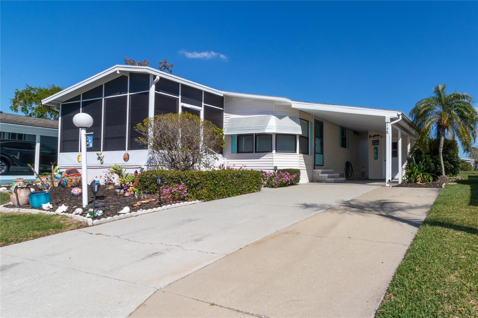 Beautiful, Updated land owned 2bd/2ba home in the 55+ community of Ridgewood Oaks.  This home features a large lot with an expanded driveway, large carport, an oversized storage shed and has a rear private patio for grilling or sunbathing.  Upgrades outside include:  Roof, AC, Vapor Barrier and the exterior have been freshly painted. Inside the home features a custom breakfast bar, stainless appliances, laminate flooring throughout, tile flooring in the bathrooms and a new custom shower.  Walls have been textured for a rich look and feel.  The large lanai has new custom blinds, beautiful tile flooring and has lots of room to entertain or relax and enjoy that morning cup of coffee.  The home is being sold furnished so all you need to bring is your suitcase!  This is a must-see home!  The Oaks community includes Spectrum internet and cable in its fees along with weekly lawn maintenance.  A beautiful clubhouse, pool, spa, tennis courts, Pickle ball courts, shuffle board and a fun outdoor fitness area.  Golf cart and small pet friendly.  Ridgewood has close access to I-75, many restaurants, the Ellenton Outlet Mall, Manatee County Library and provides 24-hour gated security.  The Oaks, a Ridgewood community offers many activities and social events to enjoy. Make an appointment to see this home today!