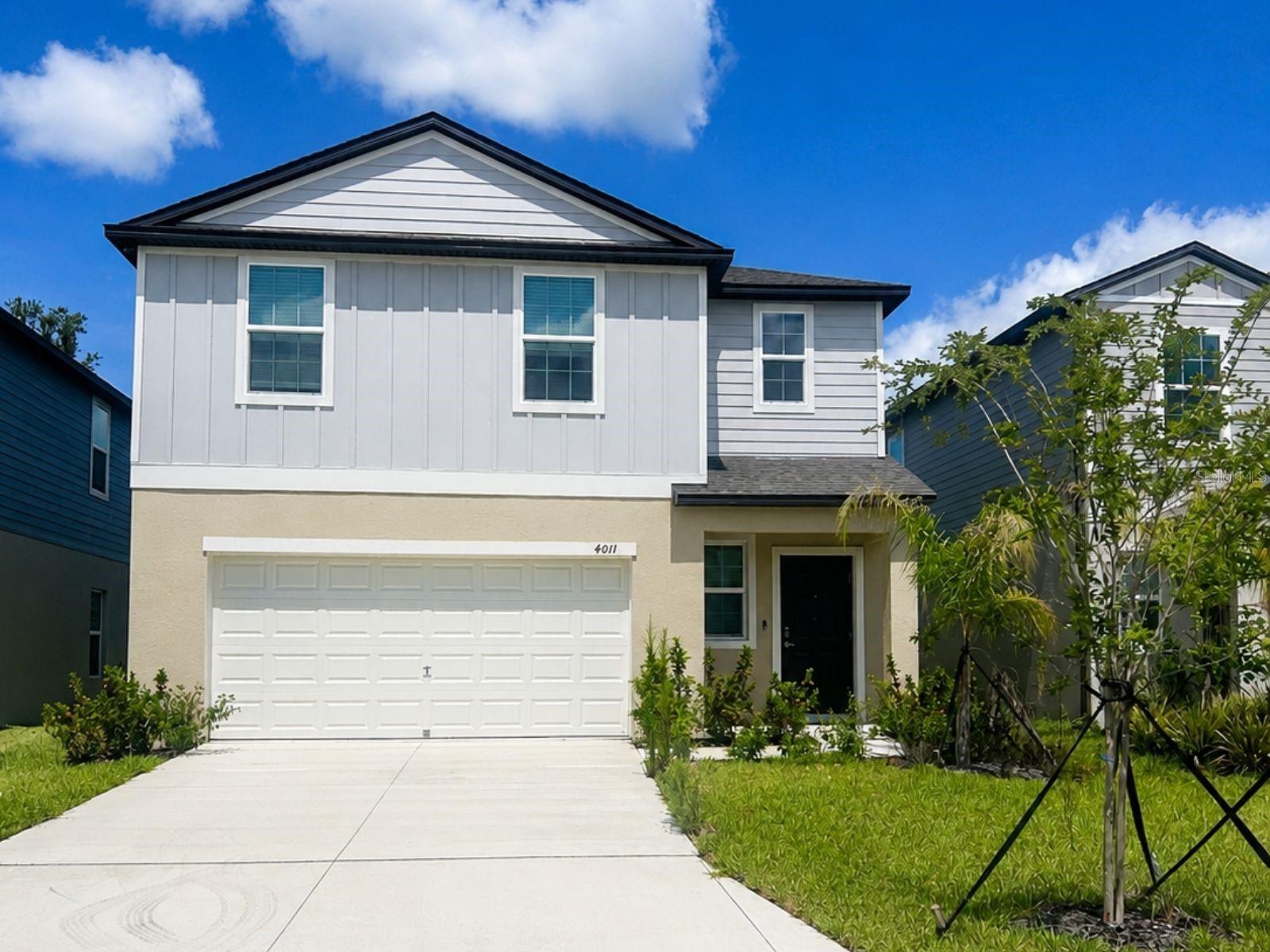 Short Sale. This two-story home features a modern exterior with mixed siding, a two-car garage, concrete driveway, covered entry, and solar panels.

Inside offers an open-concept layout with neutral tile flooring, recessed lighting, and bright, modern finishes throughout. The kitchen showcases sleek cabinetry, light countertops, a center island, and stainless steel appliances. Sliding glass doors open to the backyard, enhancing the home's airy feel.

The primary bathroom features a double vanity and a tiled shower.

Out back, a covered patio overlooks a fenced yard with partial pond and green space views.

Short sale subject to third-party approval.
