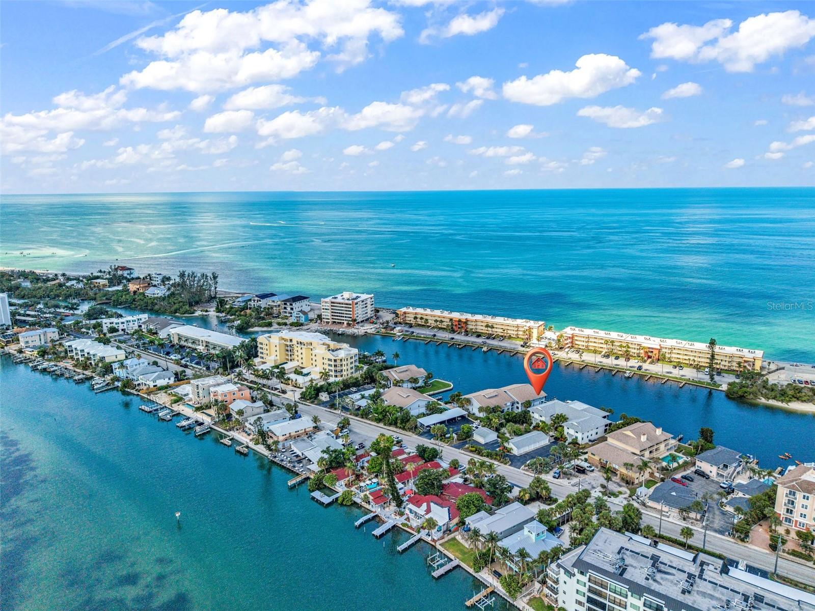 Experience the best of Siesta Key from this beautifully updated waterfront corner condominium, perfectly positioned on the quieter south end of the island. With panoramic views of Blind Pass, a deeded boat slip, and Turtle Beach just across the street, this is the ideal retreat for anyone who loves life on the water. Inside, the open-concept floor plan is designed to maximize the stunning views, featuring a beautifully updated kitchen with granite countertops, custom wood cabinetry, stainless steel appliances, and seamless flow into the living and dining areas. The spacious primary suite offers its own water views and direct access to the private lanai, creating the perfect spot to enjoy your morning coffee or unwind as the sun sets over the water. The guest bedroom and updated bathrooms provide comfortable accommodations for family and friends, while tile flooring throughout and an in-unit laundry room add everyday convenience. This well-maintained waterfront community offers a heated pool, covered parking, and a private storage locker. Spend your days boating, fishing, kayaking, or relaxing on the sugar-sand shores of Turtle Beach or hop on the Siesta Key trolley to explore the island's shops, restaurants, and world-famous beaches. Whether you're searching for a full-time residence, seasonal getaway, or investment opportunity, this exceptional waterfront property offers the true Siesta Key lifestyle.