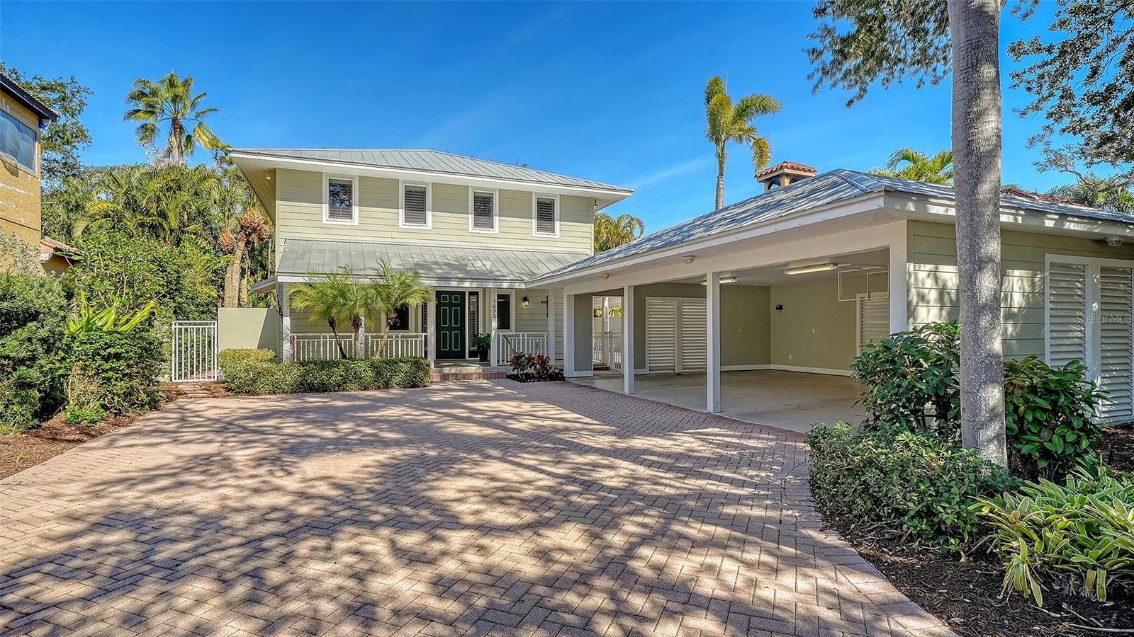 MOTIVATED SELLER!  Exceptional Living in Sarasota's Premier Southside Village. Discover quality living in one of Sarasota's most sought-after addresses. This beautifully maintained 3-bedroom, 2.5-bathroom residence offers an excellent combination of thoughtful design, premium finishes, and an enviable location just half a block from the vibrant shops and restaurants of Southside Village. The heart of this home is a spacious great room with soaring 18-foot ceiling and tasteful hand-hewn hardwood oak flooring that exudes warmth and character. A convenient dry bar equipped with its own refrigerator, wine cooler, and adjacent powder room makes entertaining effortless. Integrated surround sound creates the perfect ambiance throughout the first floor, while French doors open to a generous 20' x 12' screened lanai featuring a private relaxing hot tub. The thoughtfully designed kitchen is well suited for the culinary enthusiast, featuring an abundance of custom cabinetry with pull-out shelves, under-cabinet lighting, and expansive counter space. Premium appliances include an island-mounted DCS gas range with professional-grade hood, Sub-Zero refrigerator, Bosch dishwasher, and a built-in Miele espresso/cappuccino maker for your morning ritual. The adjacent dining area provides ample space for gathering family and friends around the table. A downstairs office showcases custom-built cabinetry and shelving, creating an ideal work-from-home environment. Quality touches throughout include solid wood core doors and a convenient in-wall vacuum system. Retreat to your spacious primary bedroom where French doors open to a private balcony overlooking mature, lush landscaping. Dual walk-in closets feature organized closet systems, while the spa-inspired en-suite bath boasts stone countertops, a solid wood vanity with dual sinks, an oversized shower with rainfall sunflower head, and a stunning Oceania jacuzzi soaking tub. Two spacious secondary bedrooms share a Jack and Jill bathroom perfect for family or guests. The upstairs laundry room is thoughtfully equipped with its own sink, folding table, and storage cabinetry. A fully equipped outdoor kitchen and patio bar complete with refrigerator, sink, gas grill w/range hood, kegerator, and granite bar provide a great gathering spot. Hurricane impact windows throughout, a metal roof, and resilient Hardie board siding provide exceptional protection against Florida's elements. Situated 20+ feet above base flood elevation, flood insurance is not required, offering both security and long-term savings.  3-car carport. In addition to the amenities of Southside Village you're in close proximity to Sarasota Memorial Hospital, downtown Sarasota, top-rated schools including Sarasota High and Southside Elementary and only 5 miles to world-renowned Siesta Key beach  Everything you love about Sarasota living is moments away. This exceptional residence offers the complete package: prime location, superior construction, thoughtful amenities, and the ultimate Sarasota lifestyle. Schedule your private showing today.
________________________________________