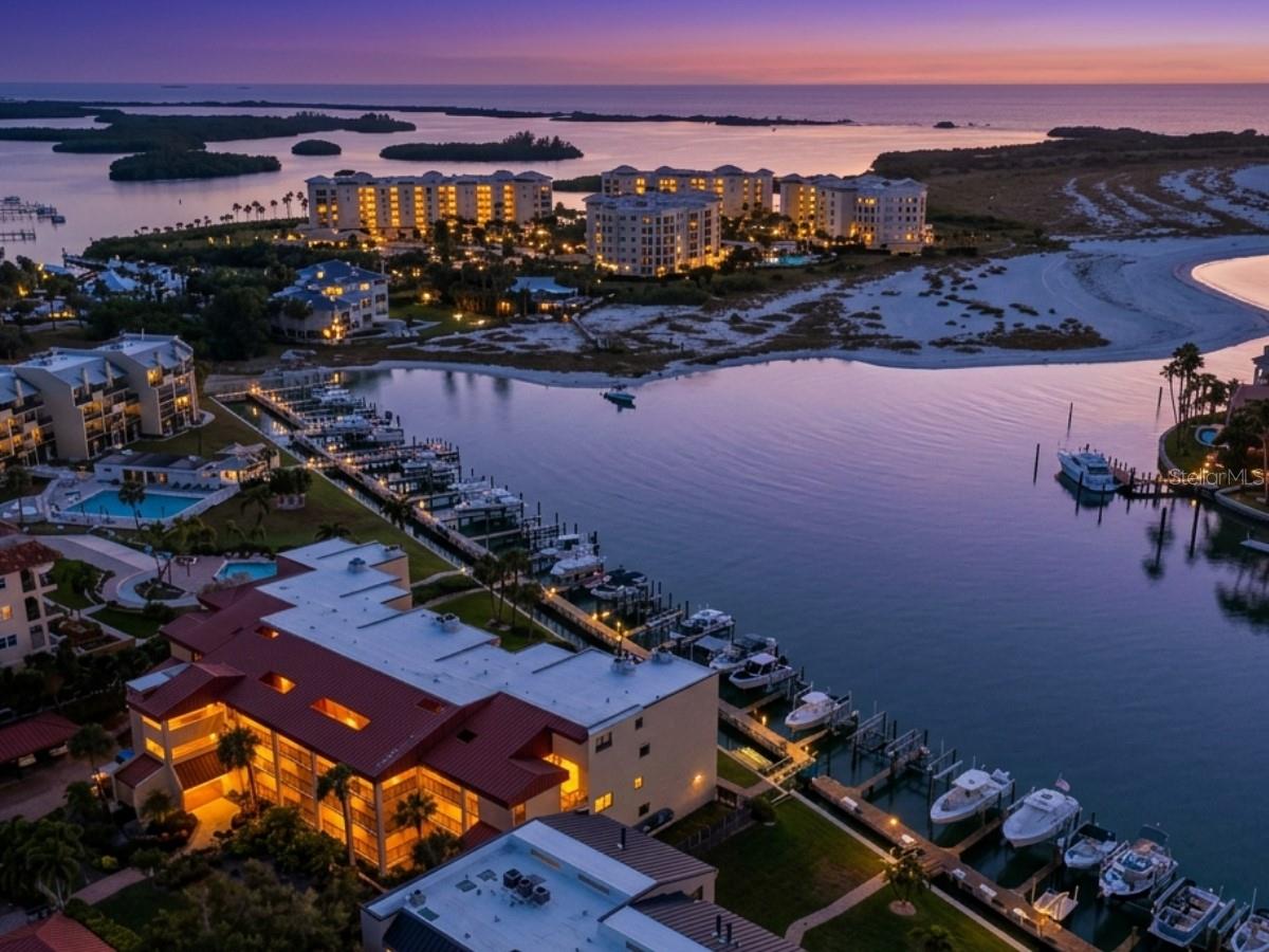 MAJOR PRICE REDUCTION — now $125,000 below original list! Rare FIRST-FLOOR waterfront in one of only THREE Tierra Verde communities with this panorama. Walls of glass frame the curve of the Grand Canal, white-sand beaches, Dents Channel, and the Gulf surf rolling in along Shell Key Preserve. Three oversized private balconies serve up sunrise over the canal, afternoon light on the water, and salt-air evenings off the master suite. Across the channel sit $8–10M mansions; the beach is an easy stroll away. Inside, an updated kitchen with warm wood cabinetry, floor-to-ceiling hurricane-rated sliders, protective shutters, a brand-new A/C, and rare heated floors on the main level. Best of all: NO history of water intrusion or storm damage—even through past storms—offering peace of mind few waterfront homes can match. Resort-style amenities include a heated pool, spa, and waterfront entertainment area. Coastal Florida living at its finest—come see this view for yourself!