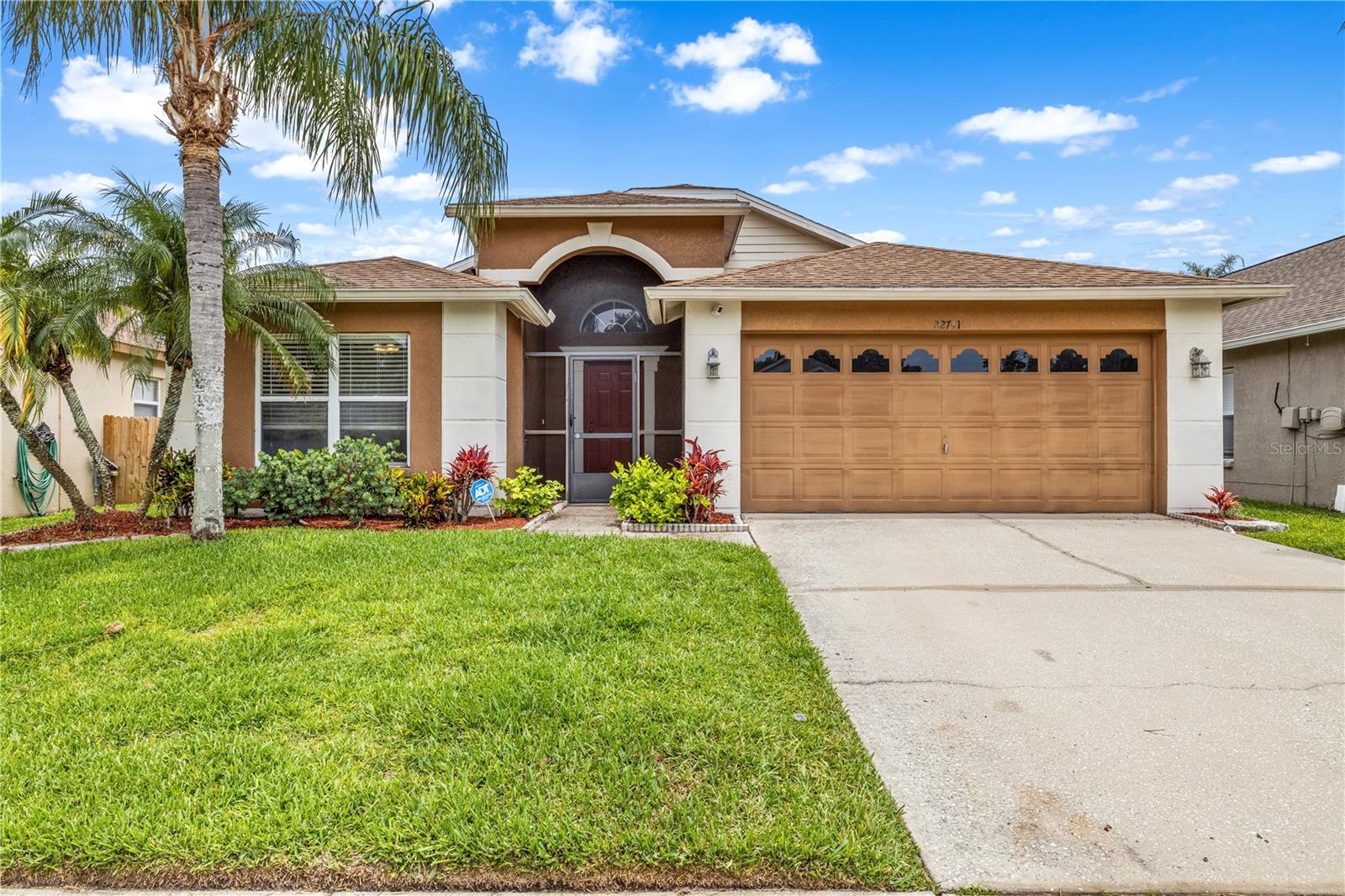 Virtually Staged. One or more photos have been virtually staged. 4-bedroom, 2-bath pool home in Land O' Lakes with low HOA. The screened saltwater pool and spa sit in a beautifully landscaped yard, visible from both the family room and kitchen — the inside and outside feel connected throughout the home.

The open layout features vaulted ceilings, wood and tile flooring, and a kitchen with white cabinetry and stainless appliances that overlooks the family room. The primary suite is generously sized with a walk-in closet and en-suite bath with dual sinks. The secondary bath also features dual sinks and a tub/shower combo.

Well-maintained and move-in ready, located near parks, shopping, dining, and golf in a desirable Land O' Lakes neighborhood.