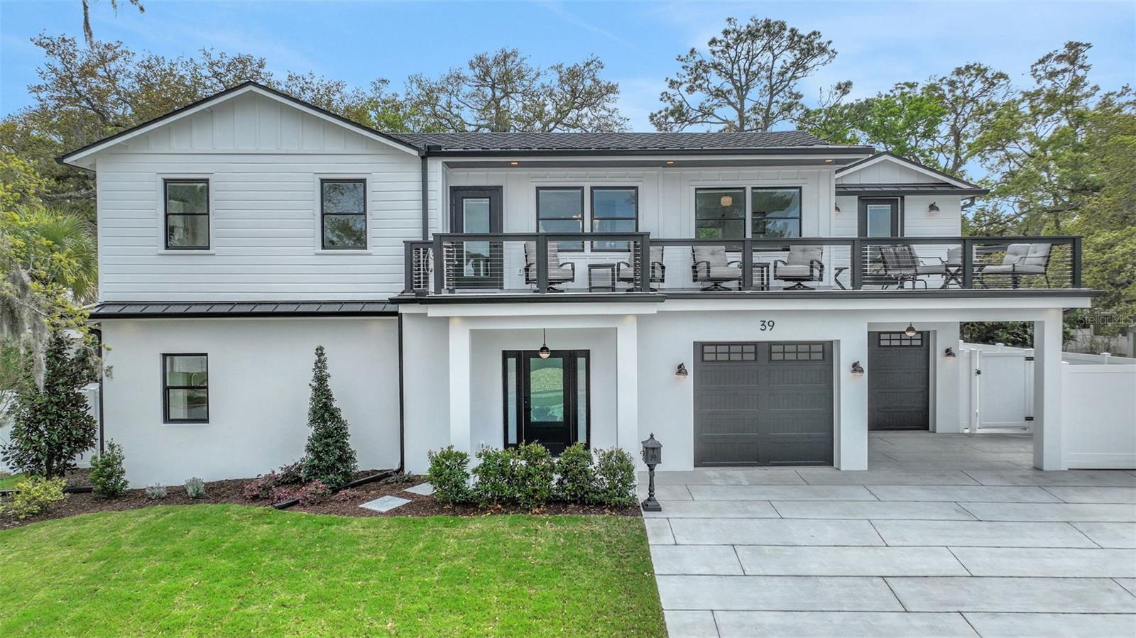 In the heart of Fullerwood, one of Uptown St. Augustine's most established and character-rich neighborhoods, you'll find an exceptional blend of charm and modern sophistication at 39 E Park Avenue. This top-to-bottom renovated pool home features 3 bedrooms, 4 full baths, and 1 half bath across more than 2,500 square feet of living space, perfectly situated less than two miles from Historic Downtown St. Augustine and just minutes from the beaches of Vilano. Raised in 2025 and removed from the flood plain, the home's architectural integrity and thoughtful renovation deliver the best of both worlds: classic charm and modern security. Originally built decades ago, the property underwent a major renovation in 2022 and was elevated and completed with an all-new main level build in 2026. Step inside the newly constructed first floor to an inviting living area with tiled floors throughout, complemented by sliding glass doors that open to the lanai and outdoor living space. Here, you'll find a brand-new gas-heated pool and spa, a cozy firepit with a seating area, and a fully equipped summer kitchen, ideal for entertaining or relaxing year-round. This level also features a beautiful ensuite bedroom and a half bath for guests. Upstairs, refinished oak hardwood floors set the tone for the home's open and sun-filled main living space. The renovated kitchen (2022) impresses with custom cabinetry, Café appliance package including a wine cooler and double oven, elegant wood countertops, and a tiled backsplash. The upper level also hosts two owner's suites, each offering beautifully updated en suite baths with designer tile showers and updated fixtures. From the upstairs bedroom, step onto the large balcony to enjoy protected views and a peek at the water. Every system in this home reflects careful attention to detail and quality, including an all-new electrical panel and wiring (2025), updated plumbing, new HVAC ductwork, and roof upgrades (main roof 2022, balcony and rear metal roof 2026). Outside, a covered sitting area with an outdoor shower adds yet another touch of convenience and coastal lifestyle appeal. Fullerwood's location is unbeatable; tree-lined streets, architectural variety, and water access make it one of St. Augustine's most desirable enclaves. A neighborhood kayak launch is just down the street, offering easy access to the Intracoastal, while the vibrant Downtown Historic District is less than a five-minute drive for dining, shopping, and cultural experiences.
Whether you're looking for a primary residence, a vacation home, or an income-producing short-term rental (one-week minimum permitted), this property delivers rare flexibility, enduring value, and timeless charm in one of the most coveted areas of St. Augustine.