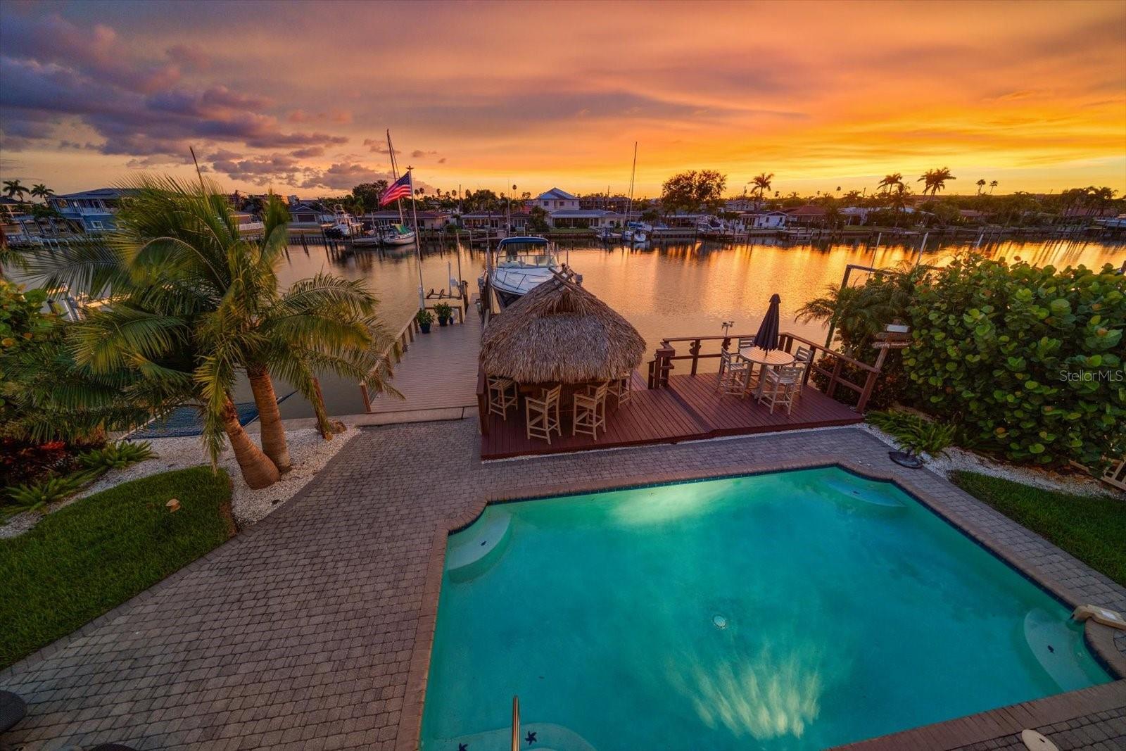 One or more photo(s) has been virtually staged. PRICED TO THE MARKET - NOW IT'S TIME TO MAKE IT YOUR OWN!  Take a look at that sunset, imagine that's yours, every single evening, from the top-floor terrace of your own Key West–style waterfront estate, watching the Gulf light up in burnt orange and gold. This is not a lifestyle you rent. This is one you own.THE ONLY ELEVATED, TRUE 5-BEDROOM WATERFRONT HOME ON THE BARRIER ISLANDS UNDER 2.3M!ON THE WATER. Deep saltwater canal. Direct Gulf access through John's Pass — zero low bridges. 20,000 lb lift. Updated composite dock with power and water. Open water in minutes. This is a real boater's home, not a "waterfront" with a view of someone's backyard.INSIDE THE HOME. 4,000+ SF open and airy — built for entertaining. Chef's kitchen. Game room. Dedicated office. 4-car tandem garage. Heated saltwater pool surrounded by a lush waterfront oasis. The entire third floor? Your primary suite — private, spa-inspired, with its own terrace above the water.DONE. ALL OF IT. New metal roof (2019). Two new AC systems (2019). Two new water heaters (2022). Fresh exterior paint (2023). New pool pump and salt generator (2025). The sellers didn't just maintain this home — they upgraded it. Pack your bags.WHERE YOU ARE. Minutes to the Gulf. Minutes to the white sand of Treasure Island and St. Pete Beach. Close to world-class dining, nightlife, and the electric energy of downtown St. Pete. All of it — no HOA.The sellers are motivated, the home is immaculate, and there is nothing else like this available at this price — not here, not on these islands. The moment you walk onto that sunset terrace, you'll know. The only question is whether someone else gets here first.