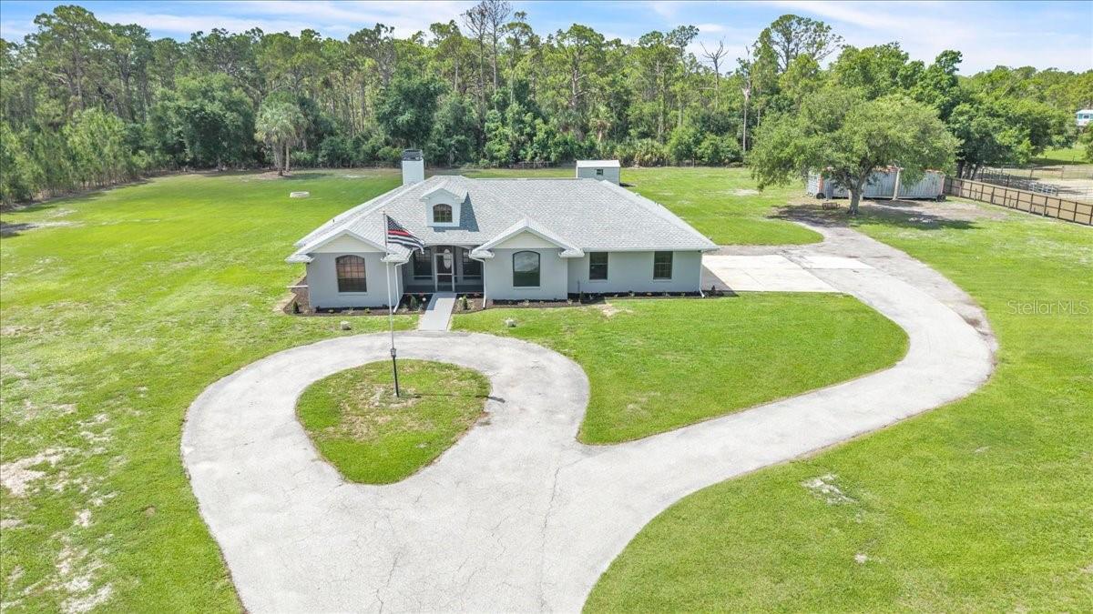 One or more photo(s) has been virtually staged. Rare opportunity to own an AG-zoned property in the highly desirable North Port Charlotte Estates—offering the perfect balance of rural freedom and everyday convenience. This beautifully maintained 3-bedroom, 2-bathroom home boasts 2,077 square feet of air-conditioned living space, complete with an attached two-car garage and a private pool—blending comfort, functionality, and an exceptional Florida lifestyle. Recent updates include a new water heater (2026), A/C system (2021), and a re-roof (2022), providing peace of mind for years to come. Set on just over three fully fenced acres, the property welcomes you through a gated driveway with coded entry, ensuring both privacy and security. A long circular drive creates an impressive approach while providing ample parking and easy guest access. A screened front patio offers a charming introduction to the home. Inside, the spacious great room serves as the heart of the home, filled with natural light and enhanced by soaring vaulted ceilings and dual ceiling fans. A striking wood-burning fireplace anchors the space, complemented by a wood-paneled accent wall that adds warmth and character. Large sliding glass doors open seamlessly to the outdoor living area, creating a true indoor-outdoor experience with direct access to the pool. Architectural details such as an arched doorway, custom ceiling lines, and wood trim accents add charm and visual interest, while the flexible layout easily accommodates a variety of furniture styles. The bright, inviting kitchen features an abundance of natural wood cabinetry that provides ample storage, while light countertops and neutral tile flooring create a clean, versatile look. The open design features a generous breakfast bar for casual dining and a sunlit breakfast nook surrounded by windows—perfect for morning coffee. A full suite of stainless-steel appliances and recessed lighting complete the space. The kitchen flows effortlessly into both the main living area and a formal dining room, offering versatility for everyday living and entertaining alike. The laundry room is conveniently located just off the kitchen and provides direct access to the garage, enhancing everyday efficiency and flow. The owner’s suite occupies its own wing of the home, creating a serene retreat. Pocket sliding doors lead directly to the pool/patio, enhancing the home’s indoor-outdoor lifestyle. The en suite bathroom features a dual-sink vanity, dedicated prep space, a corner soaking tub, a walk-in tiled shower, and a separate water closet. A spacious walk-in closet completes the suite. On the opposite side of the home, two additional bedrooms provide comfort and privacy for family or guests. One-bedroom features French doors opening to the pool and patio. Both bedrooms include built-in closets and share a full bathroom with an extended dual-sink vanity. Step outside to your private backyard oasis, where a sparkling pool and expansive sun deck create the ideal setting for relaxation or entertaining. The fenced pool area offers added safety and privacy. For added peace of mind and storm protection, the home is equipped with hurricane shutters and features two new impact-resistant PGT windows along with a new PGT pocket slider. With wide-open green space and room to roam, this property embodies tranquil Florida living—yet remains conveniently close to shopping, dining, and everyday amenities.
*PLEASE ENJOY THE 3D INTERACTIVE VIRTUAL TOUR ASSOCIATED WITH THIS LISTING**