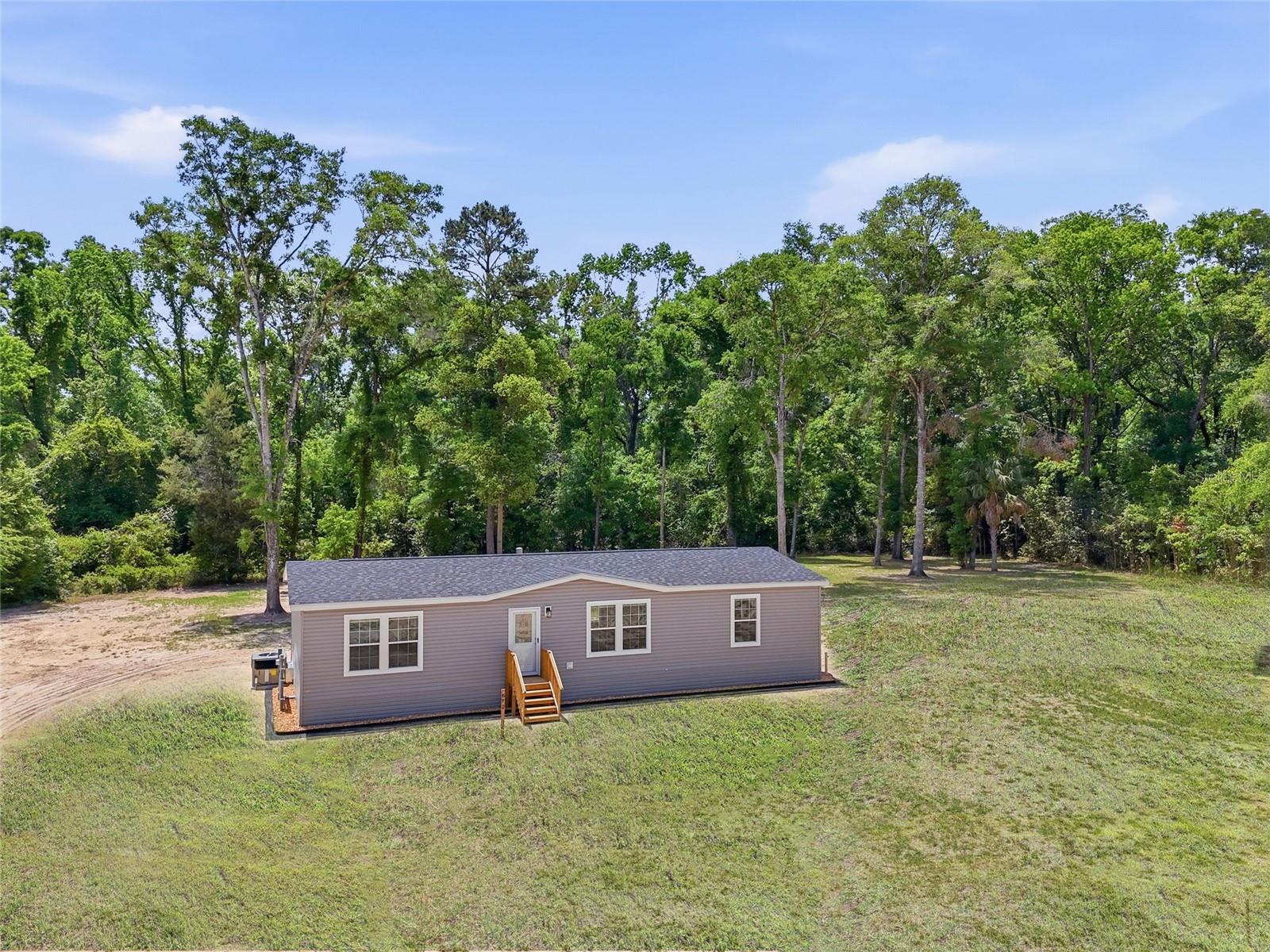 Tucked away in the highly sought-after Three Rivers Estates community, this brand-new 2026-built home offers the perfect blend of modern comfort and North Florida outdoor living. Situated on 1.37 acres along a paved road, this 3BR/2BA home features 1,493 sq. ft. of thoughtfully designed living space with an open floor plan and upgraded finishes throughout. The spacious chef’s kitchen opens seamlessly into the main living area, while still offering defined living and dining spaces for a comfortable, functional layout. The large primary suite features double vanities, a walk-in shower, and plenty of space to unwind. Two guest bedrooms share a well-appointed second bathroom, making this home ideal for families, guests, or a vacation retreat. Outside, the cleared lot is accented by scattered mature trees that provide privacy and a true Old Florida feel. Located in Three Rivers Estates, residents enjoy access to multiple private neighborhood parks along both the Santa Fe River and Ichetucknee River, offering endless opportunities for boating, kayaking, tubing, fishing, and swimming in crystal-clear springs. Nearby favorites like Ichetucknee Springs State Park, Ginnie Springs, and Blue Spring are all just a short drive away. Conveniently located between Lake City and Gainesville, you’ll enjoy easy access to shopping, restaurants, medical facilities, and the University of Florida while still being surrounded by the peaceful beauty of the North Florida countryside. Local shops, restaurants, and river outfitters nearby make this area one of the most desirable destinations for both full-time living and weekend getaways.