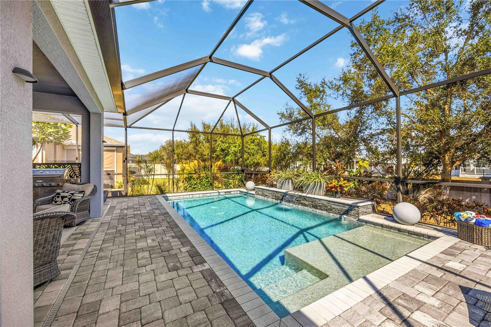 LUXURY POOL HOME WITH PRICE IMPROVEMENT + BUYER INCENTIVE! 
This stunning Arbor Reserve residence now qualifies for a Lender credit when using the preferred lender — a fantastic opportunity for buyers to reduce closing costs or assist with an interest rate. Inquire for details. Offered unfurnished, with select furniture pieces potentially negotiable upon request.
Experience elevated Florida living in this impeccably maintained Energy Star–qualified home, thoughtfully designed with upscale finishes, timeless elegance, and true indoor-outdoor living. From the moment you enter, the bright open-concept layout, soaring ceilings, porcelain tile flooring, and designer details create a warm yet elegant atmosphere that immediately feels like home.
The chef-inspired kitchen is the centerpiece of the home, featuring custom 42-inch cabinetry with crown molding, glass accent cabinets, granite countertops, stainless steel appliances, spacious center island, and seamless flow into the dining and living spaces — ideal for both everyday comfort and entertaining. Sliding glass doors open beautifully to your private outdoor retreat.
The luxurious owner’s suite offers a peaceful sanctuary with professionally customized walk-in closets and a fully renovated spa-style bathroom (2024) showcasing floor-to-ceiling tile, dual vanities, and an oversized walk-in shower with rain shower head. Additional bathrooms have also been tastefully updated with modern designer finishes.
Step outside and discover what truly makes this property exceptional — a newly installed pool and screened enclosure (2021), expansive paver lanai, covered outdoor living space, and serene landscaped surroundings with no immediate rear neighbors. This private backyard oasis was designed for relaxation, entertaining, and enjoying breathtaking Florida sunsets year-round.
Located within the exclusive gated community of Arbor Reserve, residents enjoy access to a resort-style community pool and cabana, playground, sports court, scenic lake, low HOA fees, and no CDD. Conveniently positioned near downtown Sarasota and Bradenton, top-rated schools, shopping, dining, and the world-renowned Gulf Coast beaches, this location offers the perfect balance of luxury, privacy, and convenience.
This is more than just a home — it’s a lifestyle. Schedule your private showing today and experience the elegance, comfort, and beauty that define this exceptional residence.