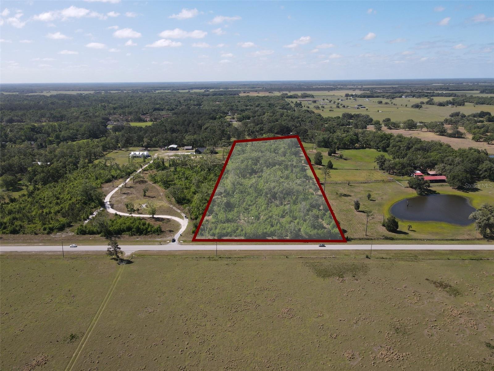 Discover the possibilities with this versatile agricultural-zoned property. Permitted uses include single-family homes, mobile homes, farming, horticulture, forestry, aquaculture, livestock, wildlife management, and a variety of agricultural operations. The property also allows for accessory agricultural buildings, roadside sales of products grown on-site, and offers potential for select special exception uses such as equestrian facilities, wineries, bed and breakfasts, hunting or fishing camps, and more, subject to county approval. Enjoy the perfect balance of privacy and convenience with easy access to the Tampa Bay area. Located within a reasonable drive of Tampa and Wesley Chapel, you'll have the peaceful setting of country living while remaining close to shopping, dining, entertainment, and major highways. Whether you're looking to build your dream homestead, start a farm, or invest in land with a wide range of permitted uses, this property offers exceptional flexibility.