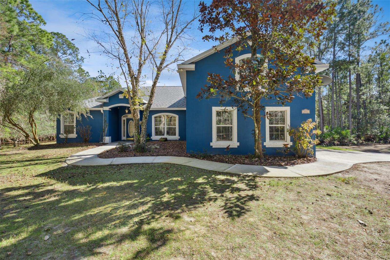 INCREDIBLE OPPORTUNITY! PRIVATE 20+ ACRE ESTATE | BACKS 7,500+ ACRE PRESERVE | PRIVATE CREEK + TRAILS | POOL & SPA | NEW ROOF 2025 | MOVE IN READY | 
Welcome to a private estate where luxury meets nature, offering over 20 acres of serene Florida landscape within the highly sought-after gated community of Summerfield Farms. Backing up to more than 7,500 acres of protected nature preserve, this property provides lasting privacy and a setting that feels truly untouched. The land itself offers a unique blend of high and low terrain, creating the perfect environment for hiking, exploring, and riding ATVs or recreational vehicles right on your own property. Whether it’s camping under the stars, enjoying the quiet around the fire pit, or simply sitting still in a deer stand watching deer pass through, this property offers a lifestyle that’s hard to find.

Inside, the home features four spacious bedrooms, including a primary suite and a second master-style bedroom, along with four full bathrooms and a large bonus room that easily functions as a fifth bedroom, office, media room, or multi-generational space. The open layout, chef's kitchen, and thoughtful design make it ideal for both everyday living and entertaining. The oversized garage offers increased door and ceiling height, perfect for larger vehicles or outdoor equipment. Built with concrete block construction and spray foam insulation, the home also includes Starlink internet, whole-home security, whole-home surge protection, and a generator hookup for added reliability.

Major Updates: Roof (2025), HVAC (2018), Water Heater & Pool Heater (2023), Well Tank (2023), Garage Opener (2024), Guest Bath (2026: countertops, sinks, faucets, hardware), Interior/Exterior Paint.

Step outside to your private retreat featuring a resort-style pool and heated spa, fire pit area, and a peaceful pond that enhances the natural beauty of the property. Surrounded by mature landscape and frequent wildlife, this is a place where you can truly unwind. With over 20 acres, preserve-backed privacy, and endless outdoor potential, this estate offers a rare opportunity to own a property that blends comfort, space, and true Florida living. Listed below appraised value, this is a unique opportunity to secure a one-of-a-kind estate in a premier gated community. Schedule your showing today!