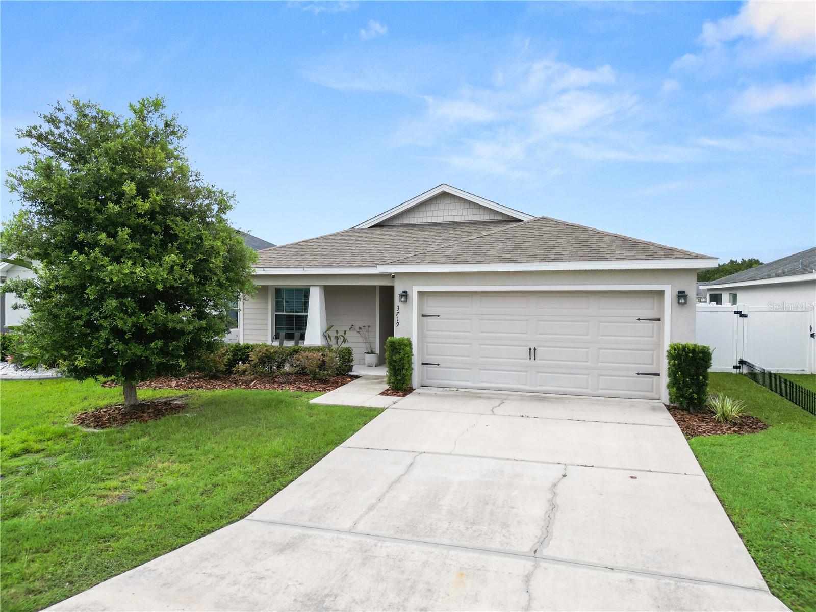 Welcome to easy Florida living in the sought after Riverstone community of South Lakeland! This beautifully maintained 4 bedroom, 2 bathroom home offers a spacious open concept design that's perfect for both everyday living and entertaining. The heart of the home is the stylish kitchen featuring a large center island, abundant cabinetry, and seamless views into the living and dining areas, all accented by durable laminate flooring throughout the main living spaces. The private primary suite is a relaxing retreat with a spacious walk in closet, dual sink vanity, soaking tub, and separate walk in shower. Three additional bedrooms provide flexibility for family, guests, or a home office. Additional highlights include a convenient indoor laundry room and a covered rear patio overlooking a fully fenced backyard with peaceful water views, the perfect place to enjoy your morning coffee or unwind at the end of the day. Located in the desirable Riverstone community, residents enjoy outstanding amenities including a resort style pool, clubhouse, playground, scenic walking trails, and convenient access to shopping, dining, with easy access to the Polk Parkway.  Don't miss your opportunity to make this beautiful waterfront home your own!