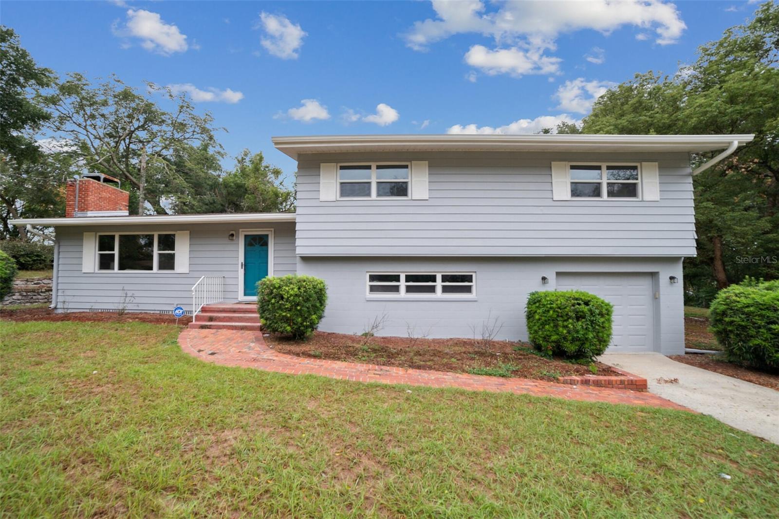 Take a look at this beautifully remodeled, unique five bedroom, two bathroom home with a 1-car garage, wood burning fireplace and large backyard. Walk through the front door into the welcoming living room with tall ceilings. A few steps downstairs takes you to the master bedroom, primary bathroom and garage. A few steps upstairs and you'll find the second bathroom and 4 other bedrooms! Fit in more family or use one as an office! Gorgeous hardwood floors in the living area and upstairs bedrooms, brand new vinyl flooring in the kitchen and spacious downstairs bedroom! This home has been painted and the kitchen and baths have been remodeled. Brand new EVERYTHING in the kitchen- new cabinets, backsplash, flooring, sleek quartz countertops and all new stainless-steel appliances. Remodeled bathrooms with new vanities, toilets, flooring and retiled showers. NEWER 2021 ROOF. Plumbing was all updated in 2005