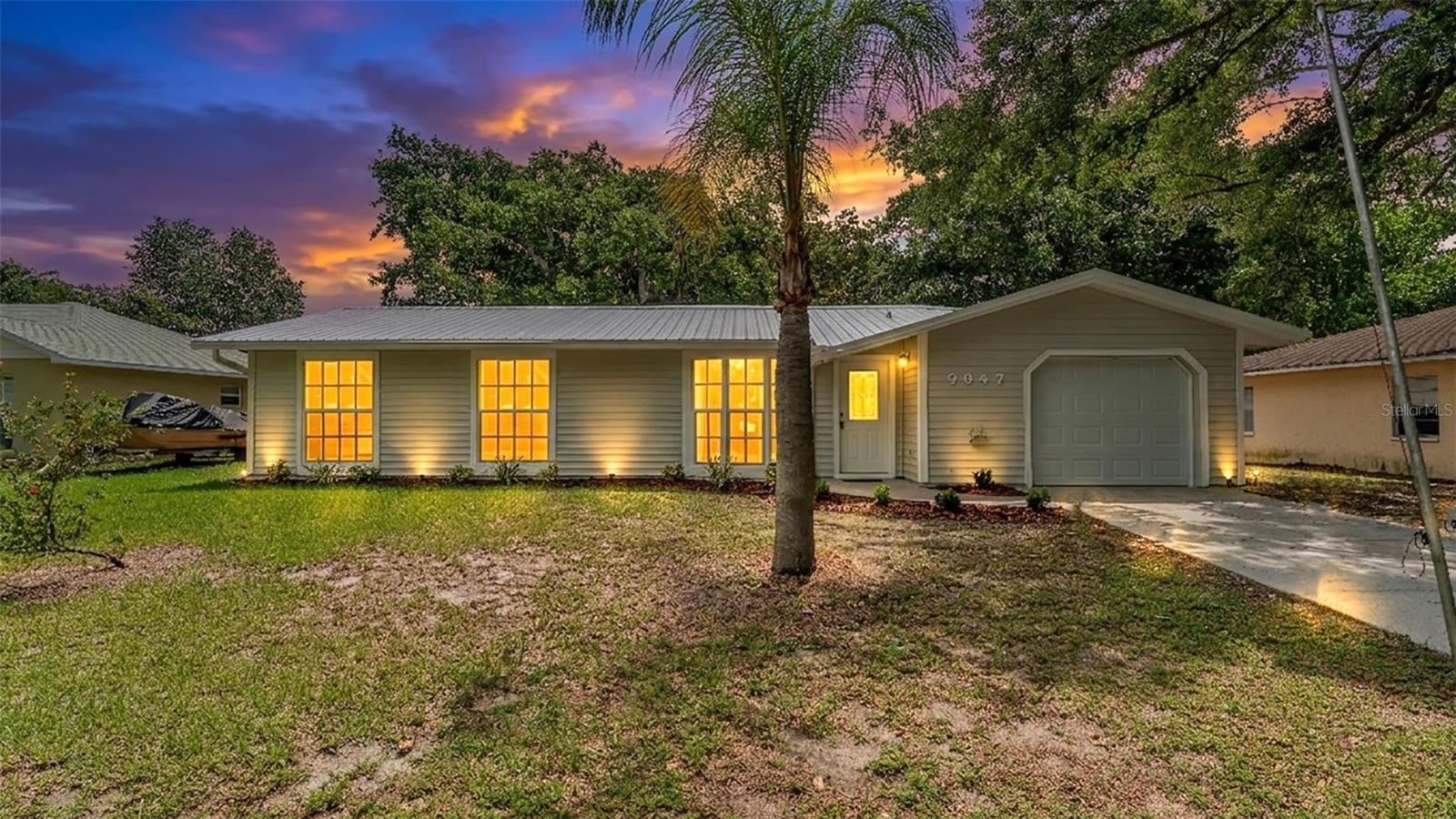 Virtually Staged. Back on the Market!!  Buyer financing fell through-
Welcome Home to Polk City Perfection!  This beautifully updated 4-bedroom, 2-bathroom home offers the perfect blend of modern upgrades, functional living space, and move-in-ready convenience. From the moment you arrive, you’ll appreciate the brand-new metal roof, fresh exterior paint, and outstanding curb appeal.  Step inside to discover a completely renovated interior featuring luxury vinyl plank flooring throughout, fresh interior paint, new baseboards, and stylish lighting, that create a bright and inviting atmosphere. The heart of the home is the stunning new kitchen, showcasing brand-new cabinetry, stainless steel appliances, modern fixtures, and contemporary finishes designed to impress. The spacious floor plan offers comfortable living for the entire family, while the enclosed and air-conditioned Florida room provides valuable additional living space perfect for entertaining, a home office, game room, or relaxing year-round. Both bathrooms have been tastefully updated delivering a fresh and modern feel. Additional highlights include a brand-new air conditioning system, new hot water heater, and new garage door. Step outside to enjoy the fully fenced backyard, offering privacy and plenty of room for pets, play, gardening, or weekend gatherings. With virtually every major component updated be sure to schedule your private showing today and experience all this beautiful home has to offer!