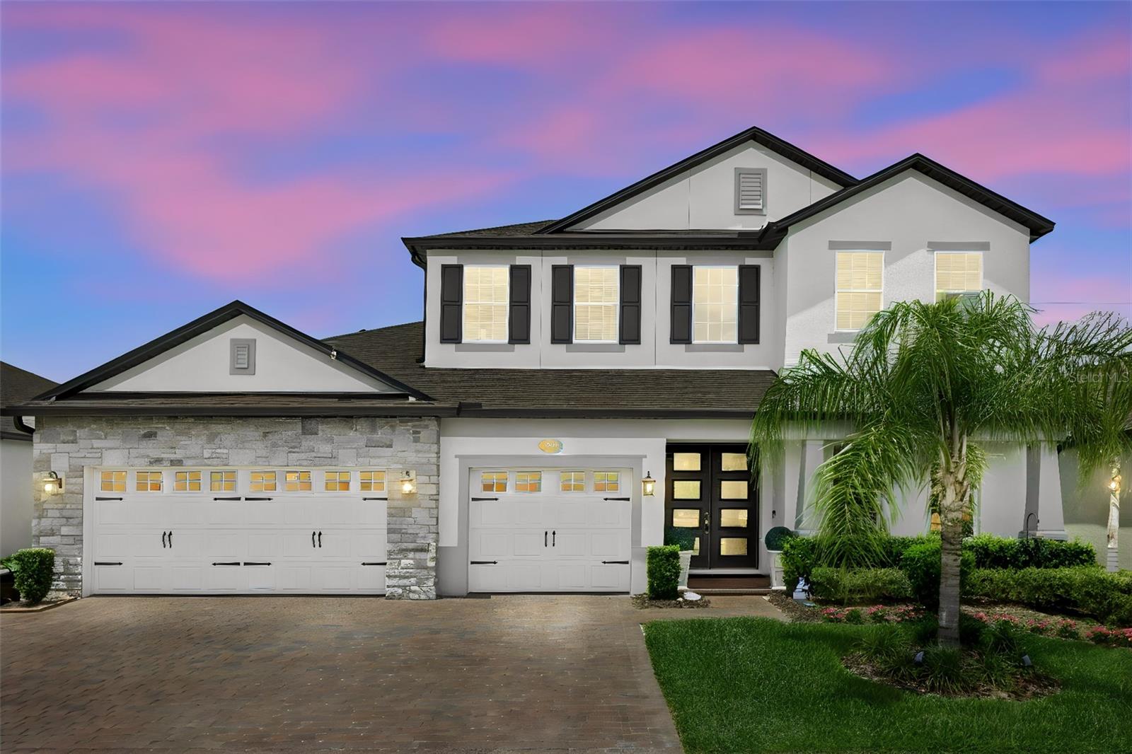Ohhhh My Goodness! Where do I start? If you are looking for a home that presents like a builder's model, inside a secured gated neighborhood {Red Ember North}, you have found it! Please allow me to walk you through this masterpiece. This home was custom built in 2022 by the current owners. The builder is M/I Homes and the model is The Tradewinds, and all of the upgrades were included. This home offers 4 full bedrooms, media room and office. The expansive en-suite primary bedroom and bathroom on the 1st level includes his and hers closets! There is a quiet office in the front of the home, and the remaining 3 large bedrooms are upstairs along with a decked-out media room including slated wall panels along with a walk-in temperature-controlled storage room. This home truly checks all of the boxes. There are 3 full bathrooms along with one half bath and a large laundry room with a full-sized stackable washer/dryer combo. The open concept kitchen leads into the family room featuring a stacked stone accent wall and built-in fireplace, and the dining room with a stunning coffered ceiling. Through the sliders your eyes are drawn to the sparkling solar-heated pool with 2 beautiful fire bowls on either side for ambiance, and a large screened enclosed patio area, perfect for those long summer days and warm summer nights. Rounding out the perfection is the oversized 3-car garage with attic storage. Oviedo is known for its A-rated schools, parks, shopping and restaurants and this neighborhood is also located just a hop-skip-and a jump from University of Central Florida (go Knights!) Schedule your showing of this showstopper and start living the carefree lifestyle this home offers to you and your family!