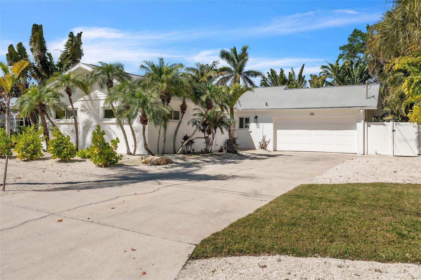 Your private island retreat awaits in this exquisitely renovated coastal cottage, situated on an oversized lot North of Pine Avenue in the city of Anna Maria. This solid concrete block, ground level residence offers 3 bedrooms and 2 bathrooms with a bright, open layout design that embodies refined island living.  Inside, elegant ceramic tile flooring, hurricane impact windows, and expansive living spaces create an inviting yet sophisticated atmosphere. The spacious living room flows seamlessly into the great room, offering the perfect setting for both relaxed coastal living and stylish entertaining. The designer chef’s kitchen features beautifully refinished cabinetry, a classic subway tile backsplash, stainless steel appliances, and a chic breakfast bar for casual dining. The serene primary suite offers a private en-suite bath, while two additional guest bedrooms provide comfortable accommodations for family and visitors. An oversized two car garage adds both convenience and storage. Step outside to your secluded backyard sanctuary, where lush tropical landscaping surrounds a sparkling pool and private cabana. Artificial turf and thoughtfully placed LED landscape lighting create an ambiance perfect for evening gatherings or peaceful island nights.
This exceptional property is part of a voluntary HOA providing access to six community boat docks with direct entry to the sparkling waters of Tampa Bay and the Gulf of Mexico. Just a short stroll away, you’ll find the pristine white sands of Bean Point, the boutiques and dining along Pine Avenue, the City Pier, the local farmer’s market, and the convenient island trolley.
Experience the very best of Anna Maria Island living and schedule your showing today to claim your slice of paradise.