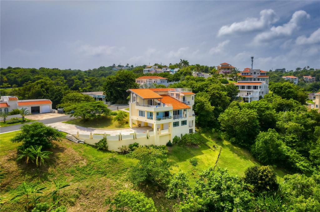 Perched atop the scenic hillside of Palmas del Mar, sits this captivating 3-story estate with awe-inspiring vistas of the ocean and flourishing tropical flora. Offering an exquisite Mediterranean Contemporary design, a privileged location sitting on over an acre of tastefully manicured land and a total square footage of 4,500 sq ft, of which 3,000 is composed of interior air conditioned space.

A serene ambience and some of the best views in PDM serve as the property's backdrop, accenting the majority of the spaces. Past the inviting foyer, the second level showcases an ensuite guest bedroom, double-height living room, gourmet kitchen and dining room, in addition to a family room which connects to a sizable covered terrace.

The third level features three bedrooms, two bathrooms and an additional terrace. The master bedroom suite includes an accommodating walk-in closet and balcony.

The ground floor houses a 3-car garage, work room, office and storage. A full-power generator is provided for added comfort and convenience.

The adjacent lot, 14 Port Road, is included with the home.

Affording the ultimate levels of comfort and convenience, Palmas del Mar is internationally renowned for its top golf courses, tennis courts, equestrian center, private school, restaurants, shopping venues and beachfront location on the southeast coast of the island. Only a 40-minute drive away from San Juan, enjoy the pinnacle of resort living while still being in close proximity to the Metropolitan area.

Annual HOA: $1,646.

Annual Hazard Insurance: $1,119.